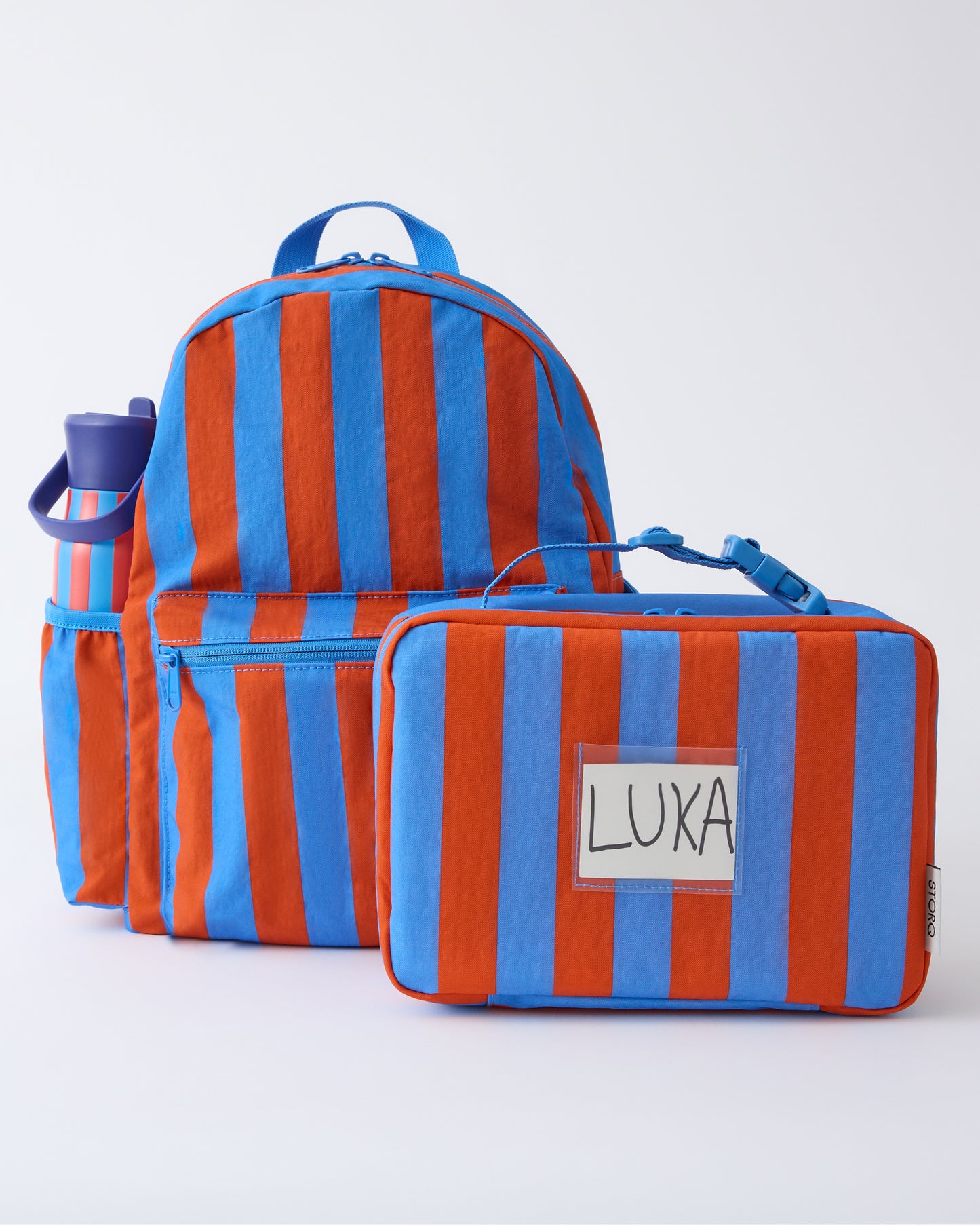 Cool Kid Backpack, Water Bottle and Lunch Box in Blue & Rust Stripe, on a beige background.