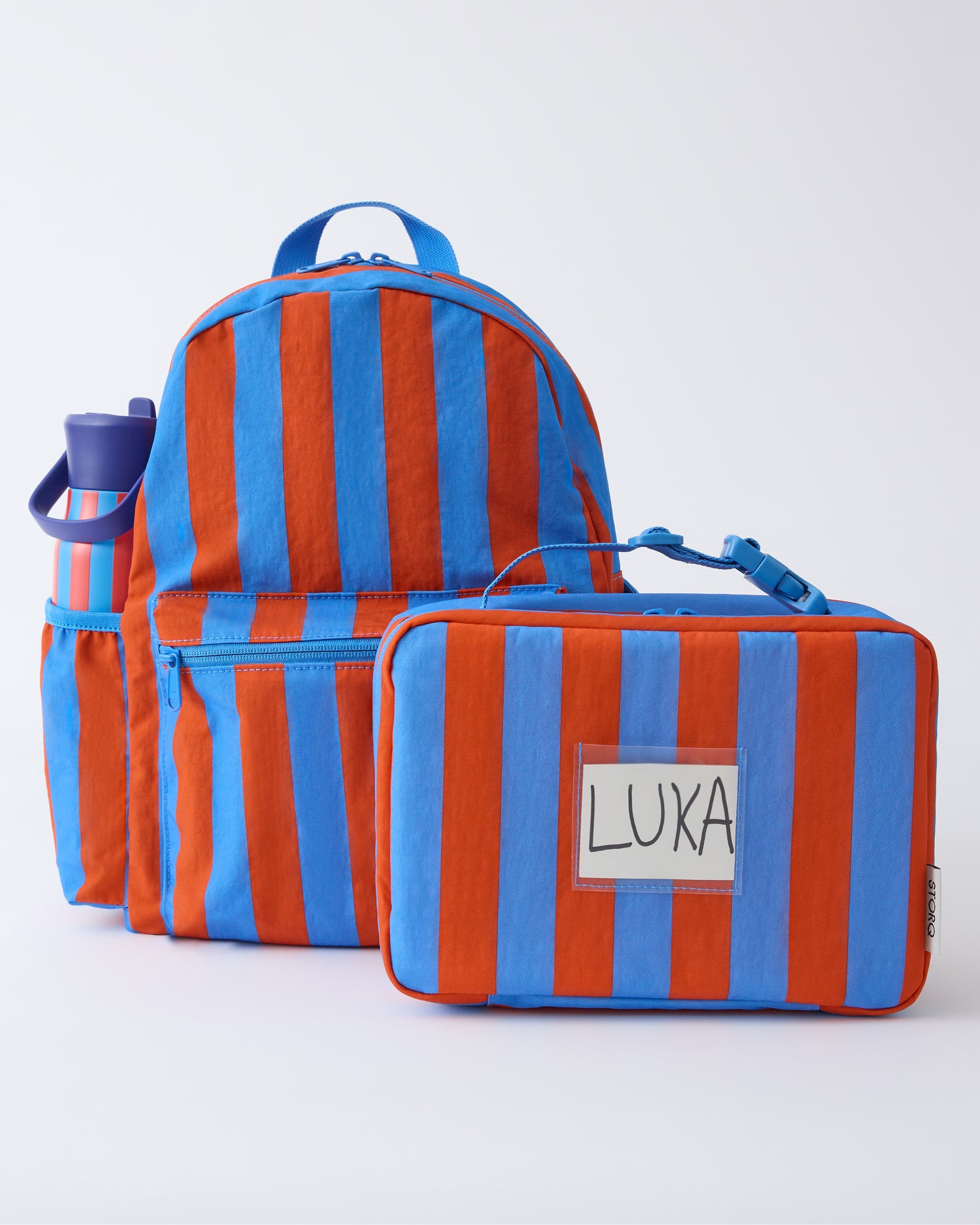 Cool Kid Backpack, Water Bottle and Lunch Box in Blue & Rust Stripe, on a beige background.