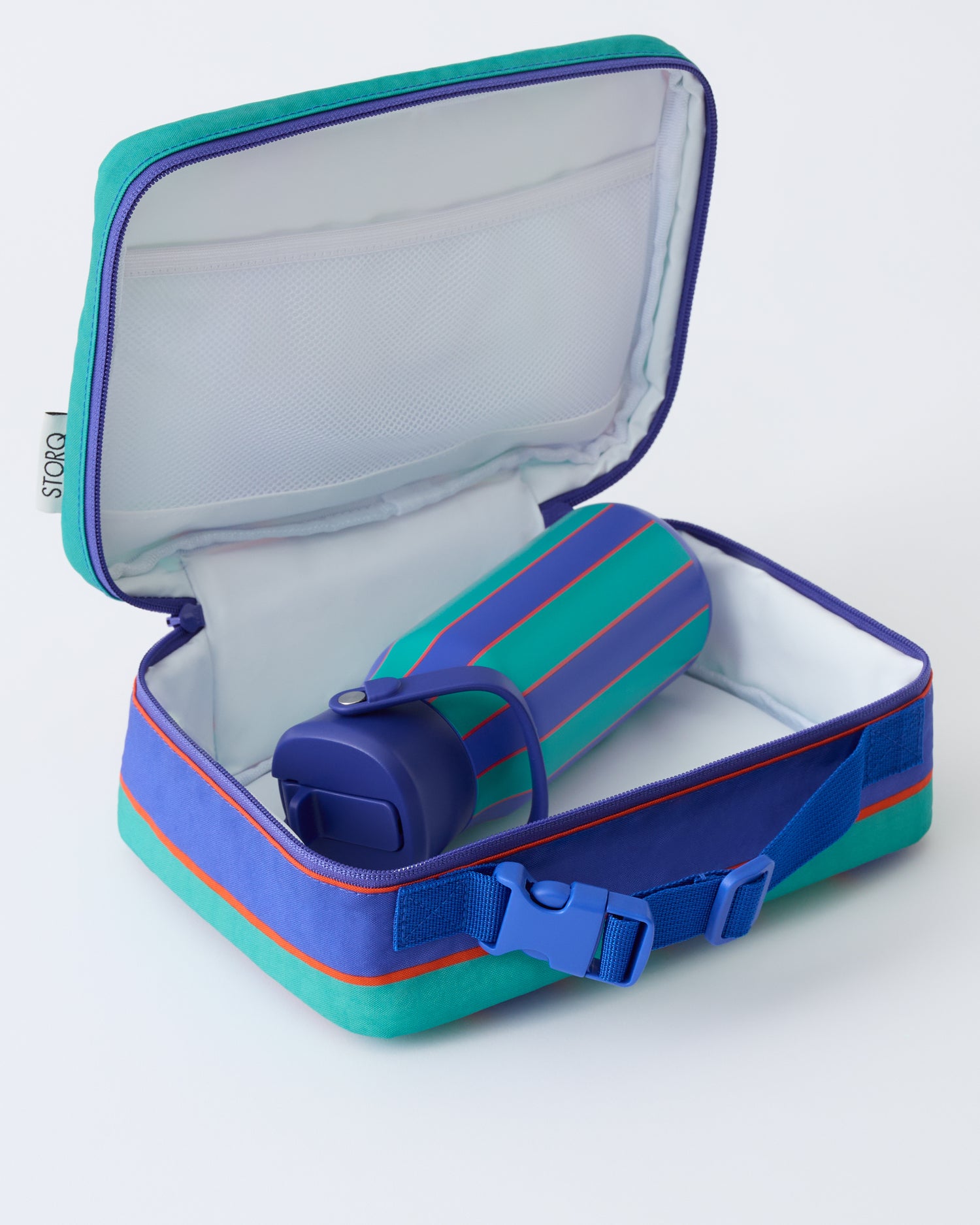 Opened view of the Cool Kid Lunch Box in Navy & Green Stripe with a Water Bottle in Navy & Green Stripe, on a beige background.
