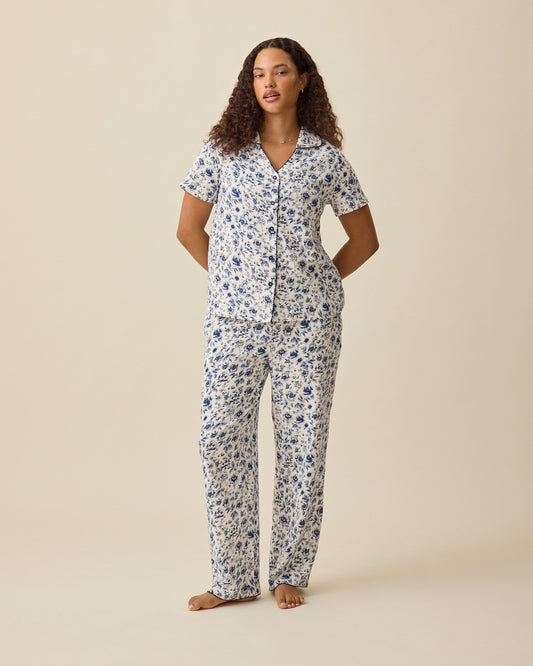 Model wearing Cotton Bamboo Pajama Set in Navy Toile on a beige background. @model_info:Mei is 5'8" and wearing a Small.