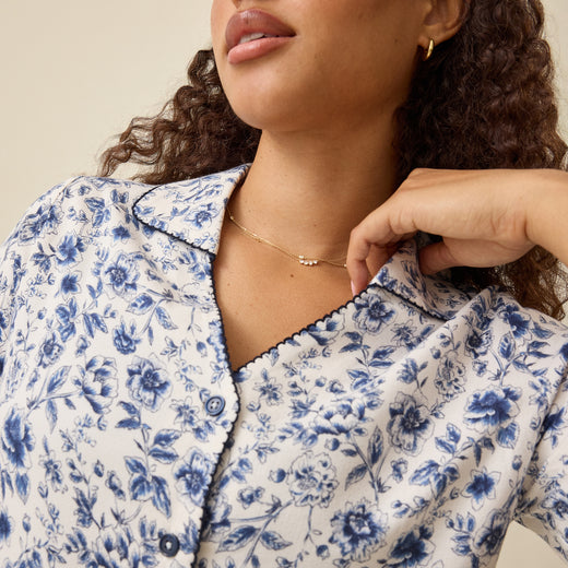 Close up of Top of Cotton Bamboo Pajama Set in Navy Toile on a beige background.