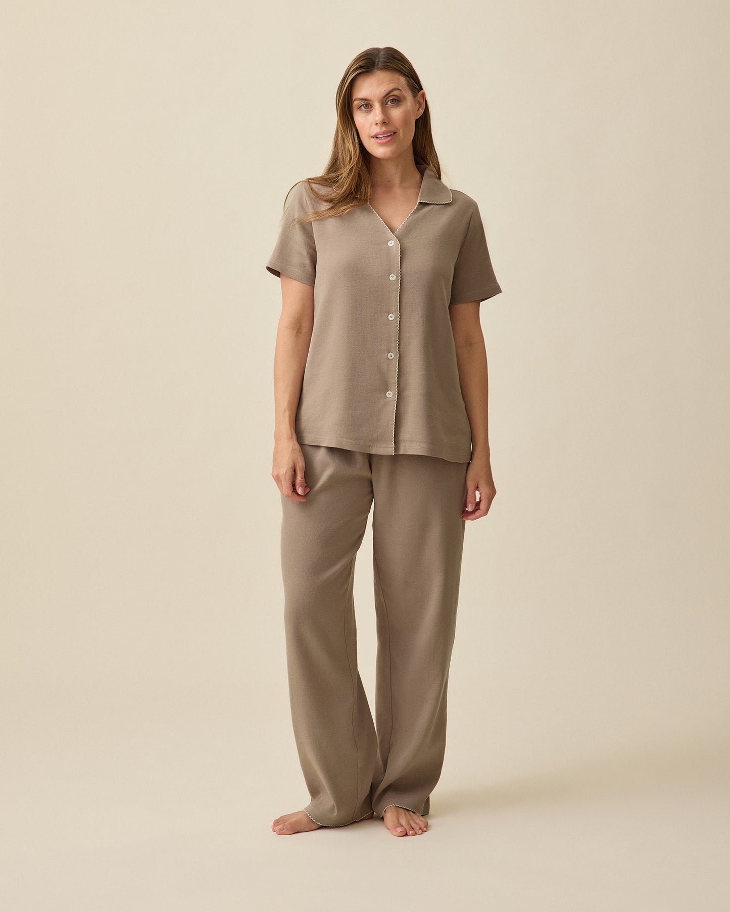 Model wearing Cotton Bamboo Pajama Set in Taupe on a beige background. 
 @model_info:Brittany is 5'7" and wearing a Small.