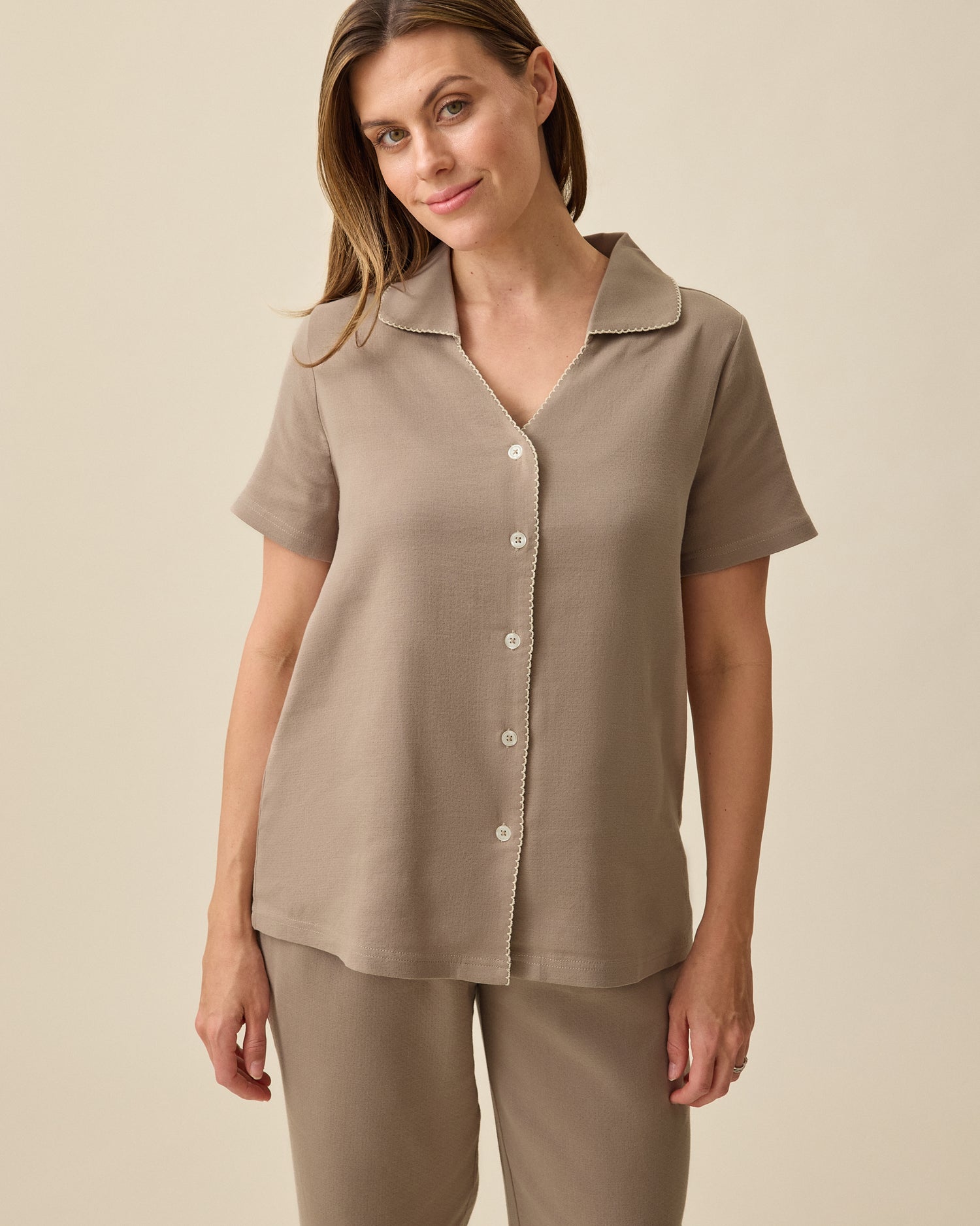 Model wearing Cotton Bamboo Pajama Set in Taupe on a beige background. 