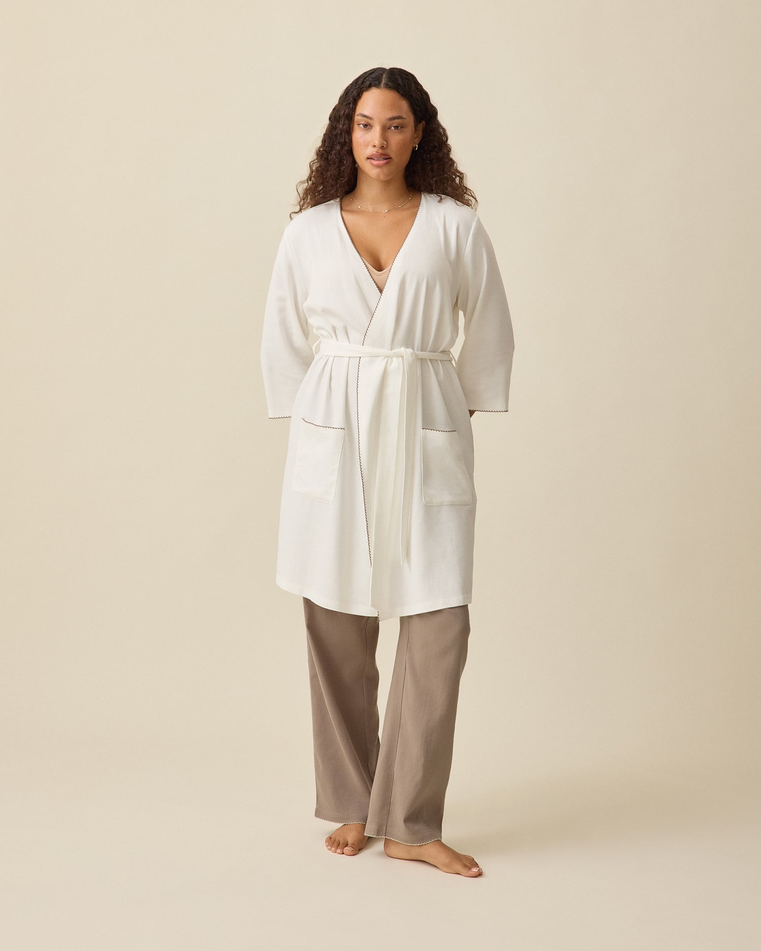 Model wearing Cotton Bamboo Robe in Ivory on a beige background @model_info:Mei is 5'8" and wearing a Small.
