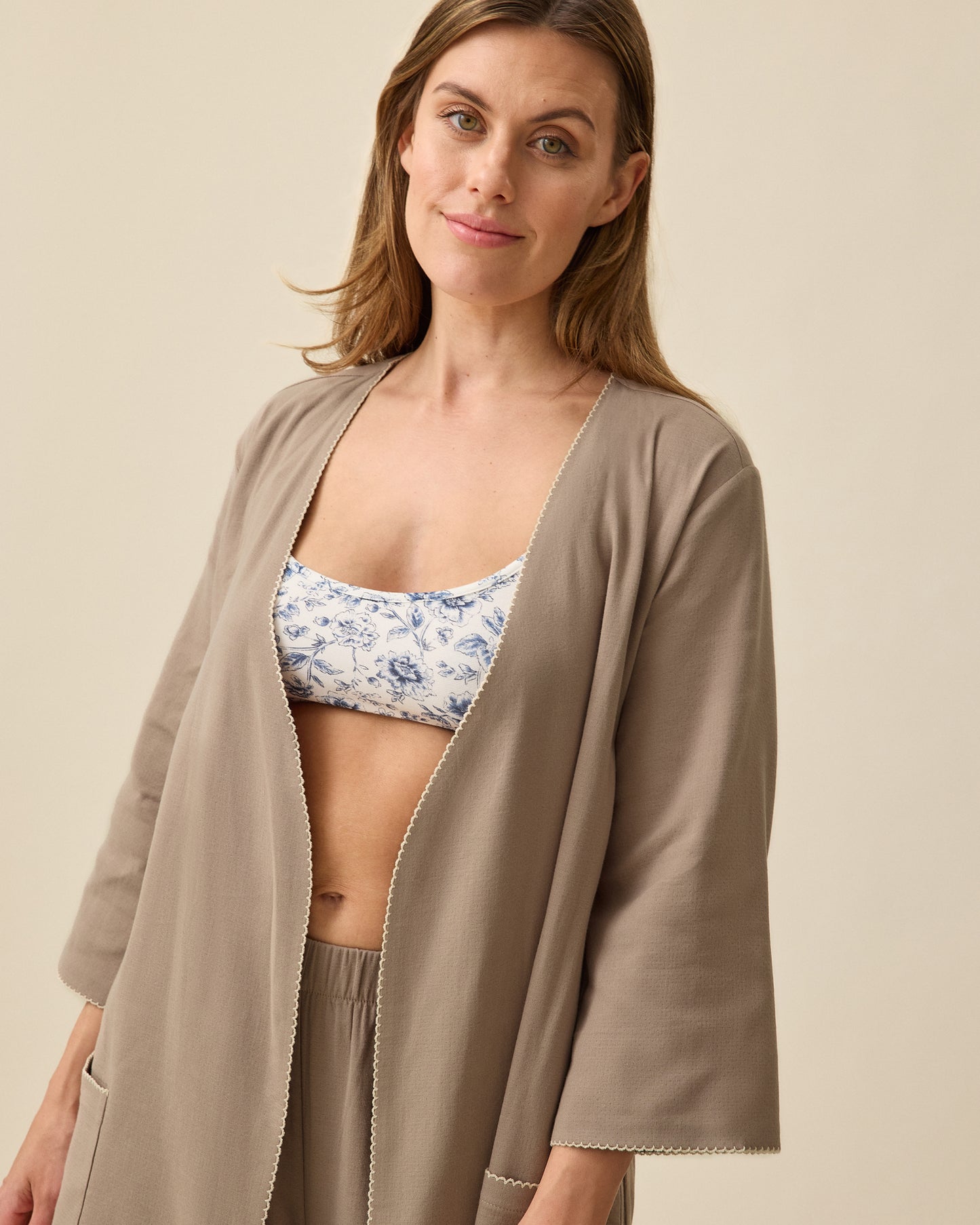 Model wearing Cotton Bamboo Robe in Taupe on a beige background