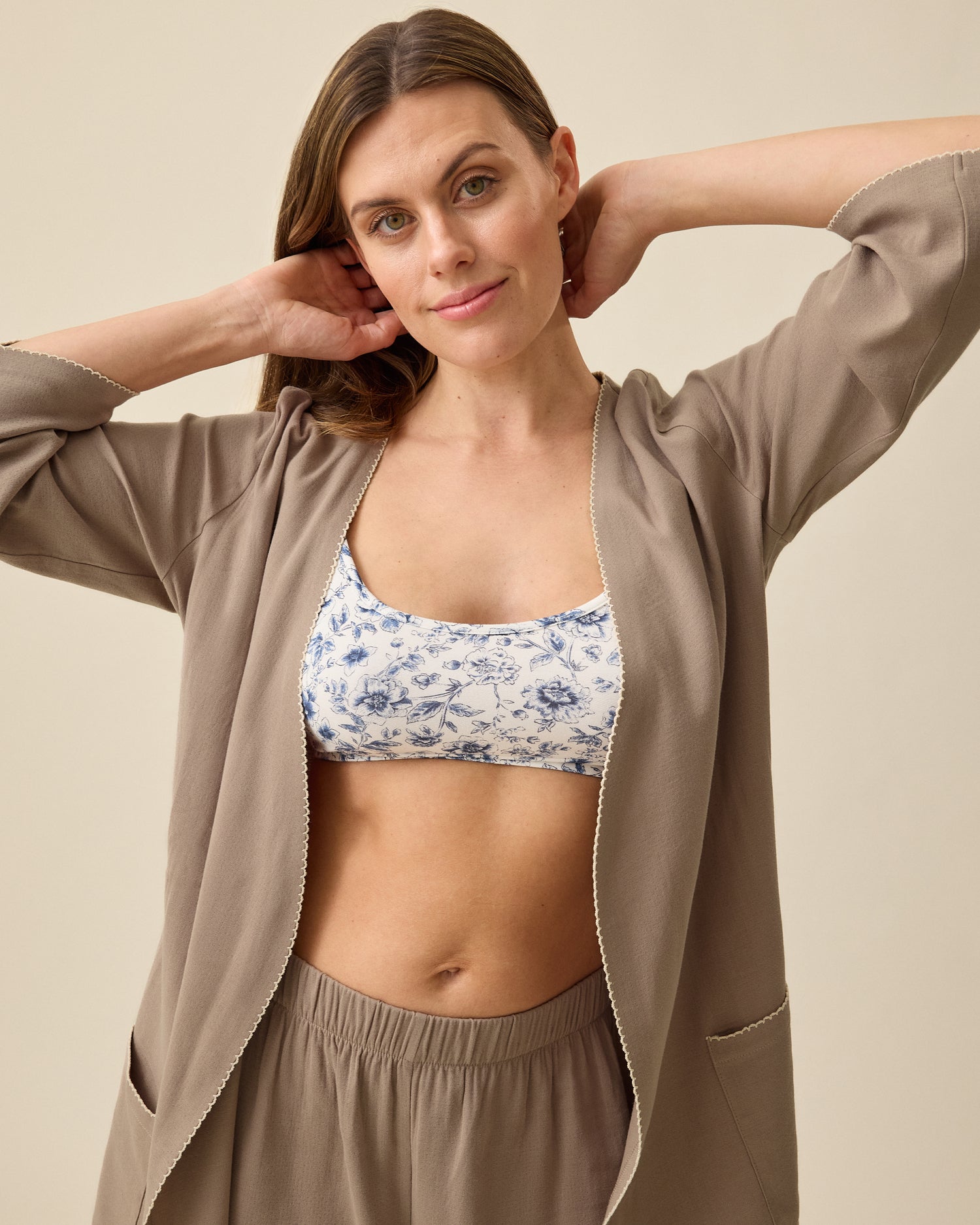Model wearing Cotton Bamboo Robe in Taupe on a beige background