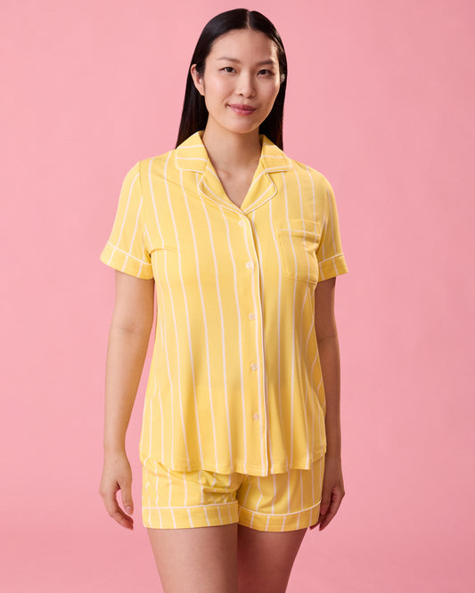 Front view of model wearing Clea Bamboo Short Sleeve Pajama Set in Dandelion Stripe on a pink background@model_info:Cassie is 5'9" and wearing a Small.