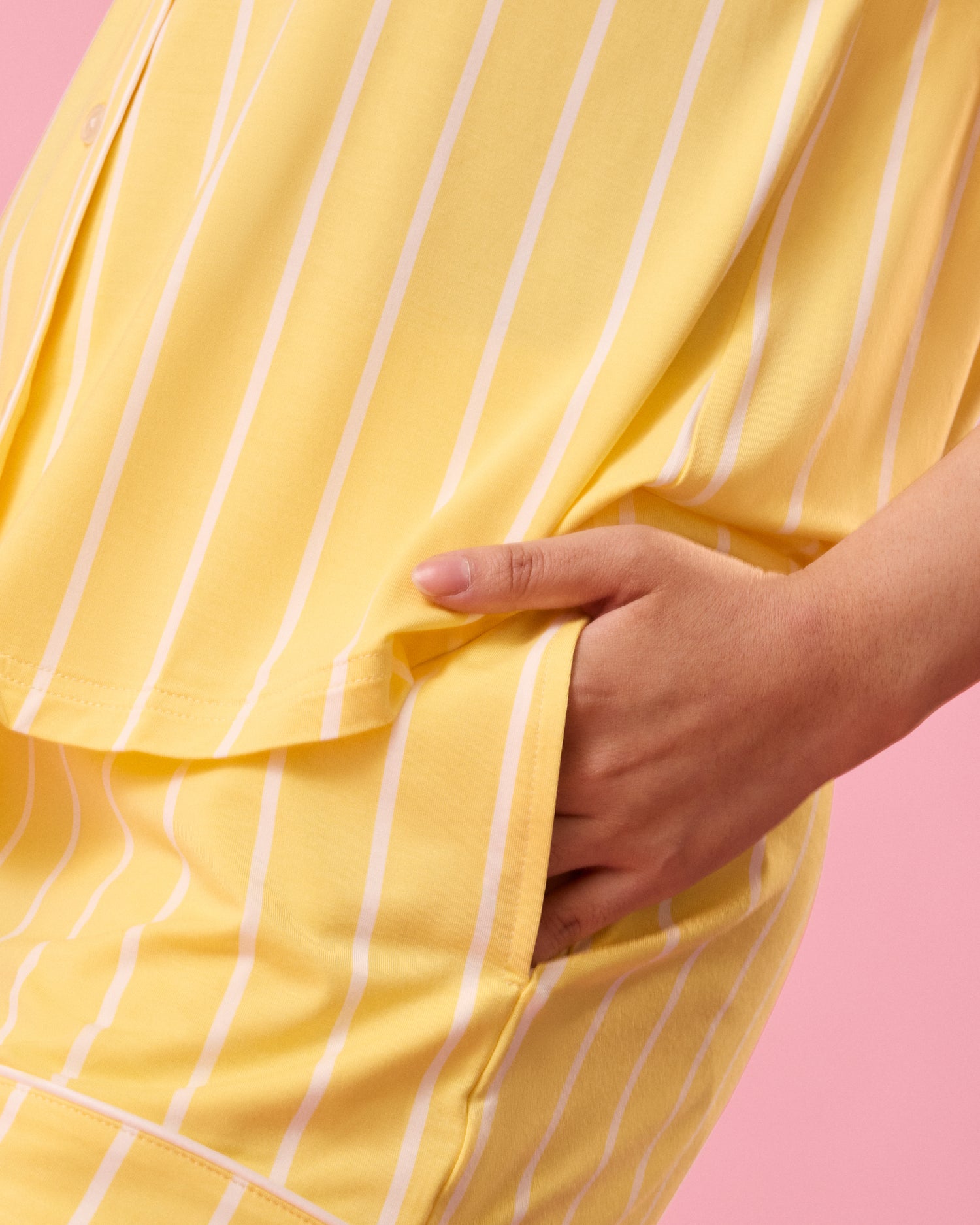 Close up of model wearing Clea Bamboo Short Sleeve Pajama Set in Dandelion Stripe showing the short's pockets