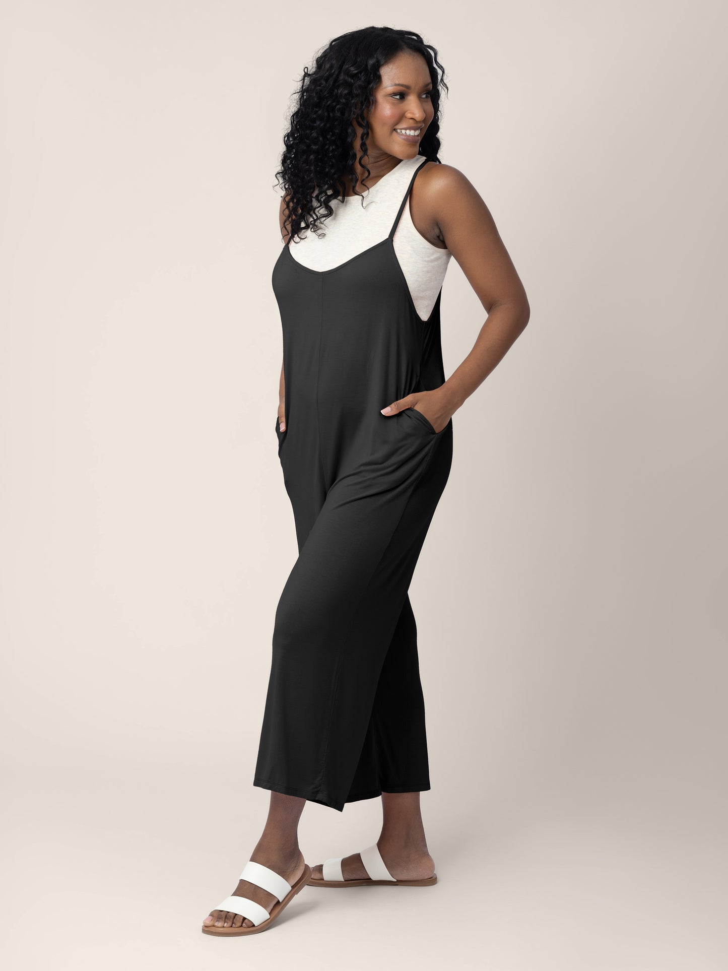 Model wearing the Charlie Maternity & Nursing Romper in Black looking to the right of the image