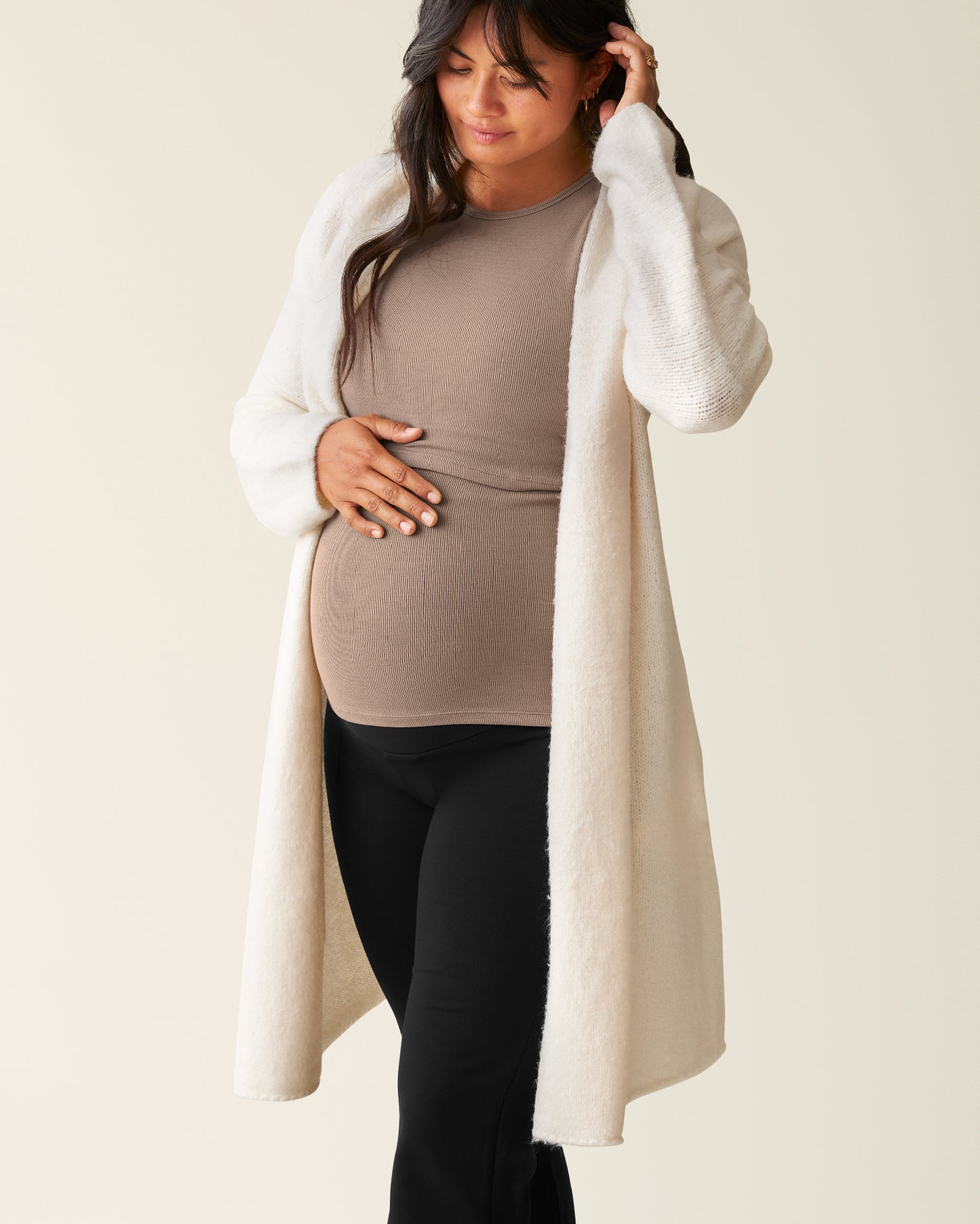 Woman wearing the Chloe Cardigan Sweater in Ecru over a Taupe top@model_info:Zoe is 5'7" and wearing an M/L.