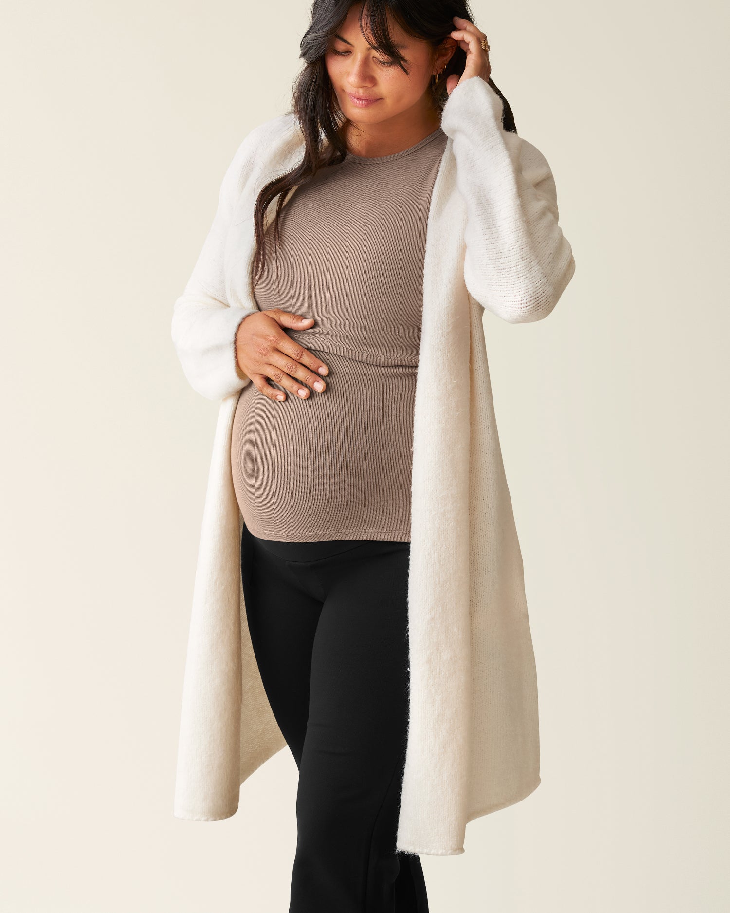 Woman wearing the Chloe Cardigan Sweater in Ecru over a Taupe top@model_info:Zoe is 5'7" and wearing an M/L.
