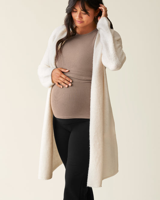Woman wearing the Chloe Cardigan Sweater in Ecru over a Taupe top@model_info:Zoe is 5'7" and wearing an M/L.