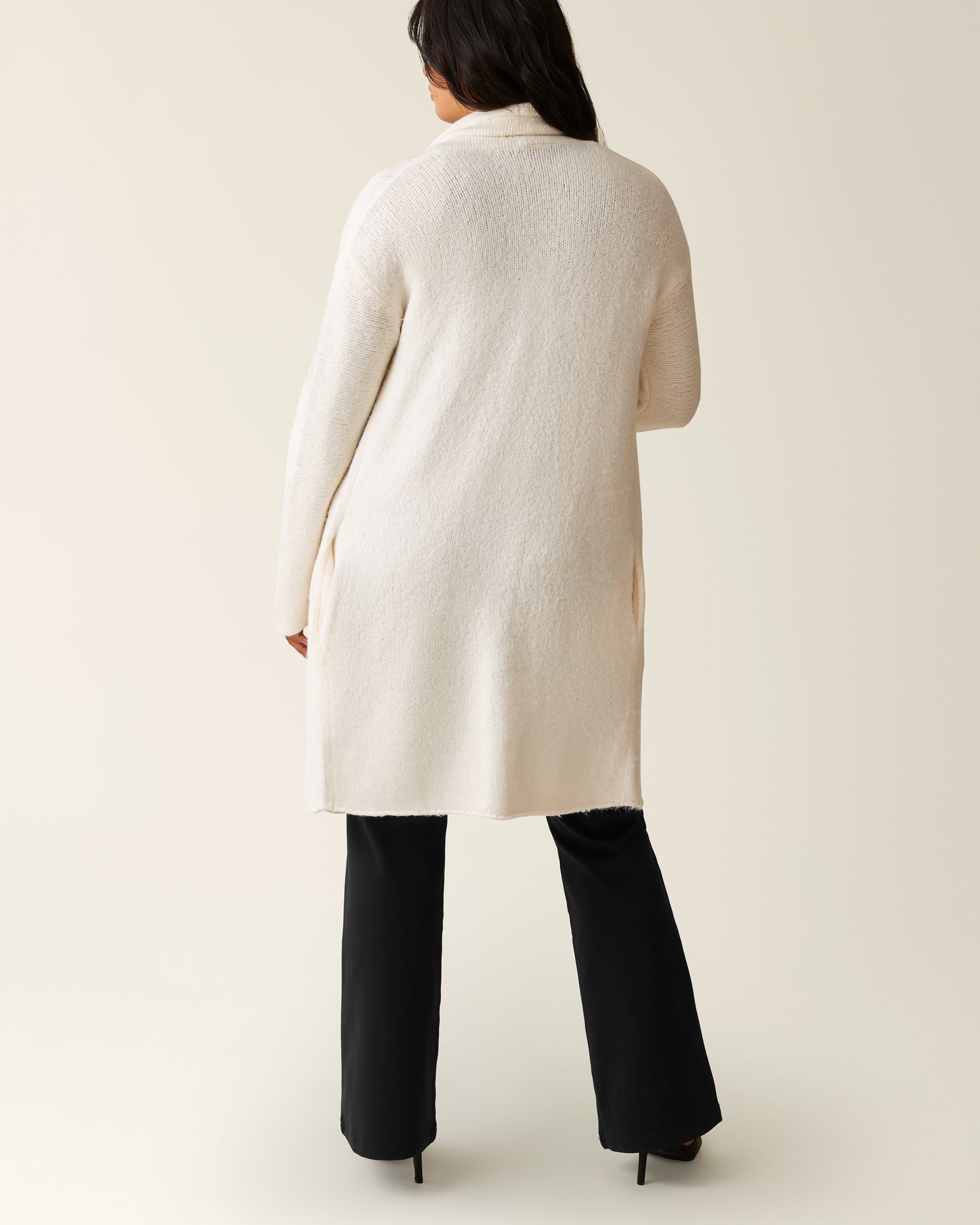 Back of woman wearing the Chloe Cardigan Sweater in Ecru 