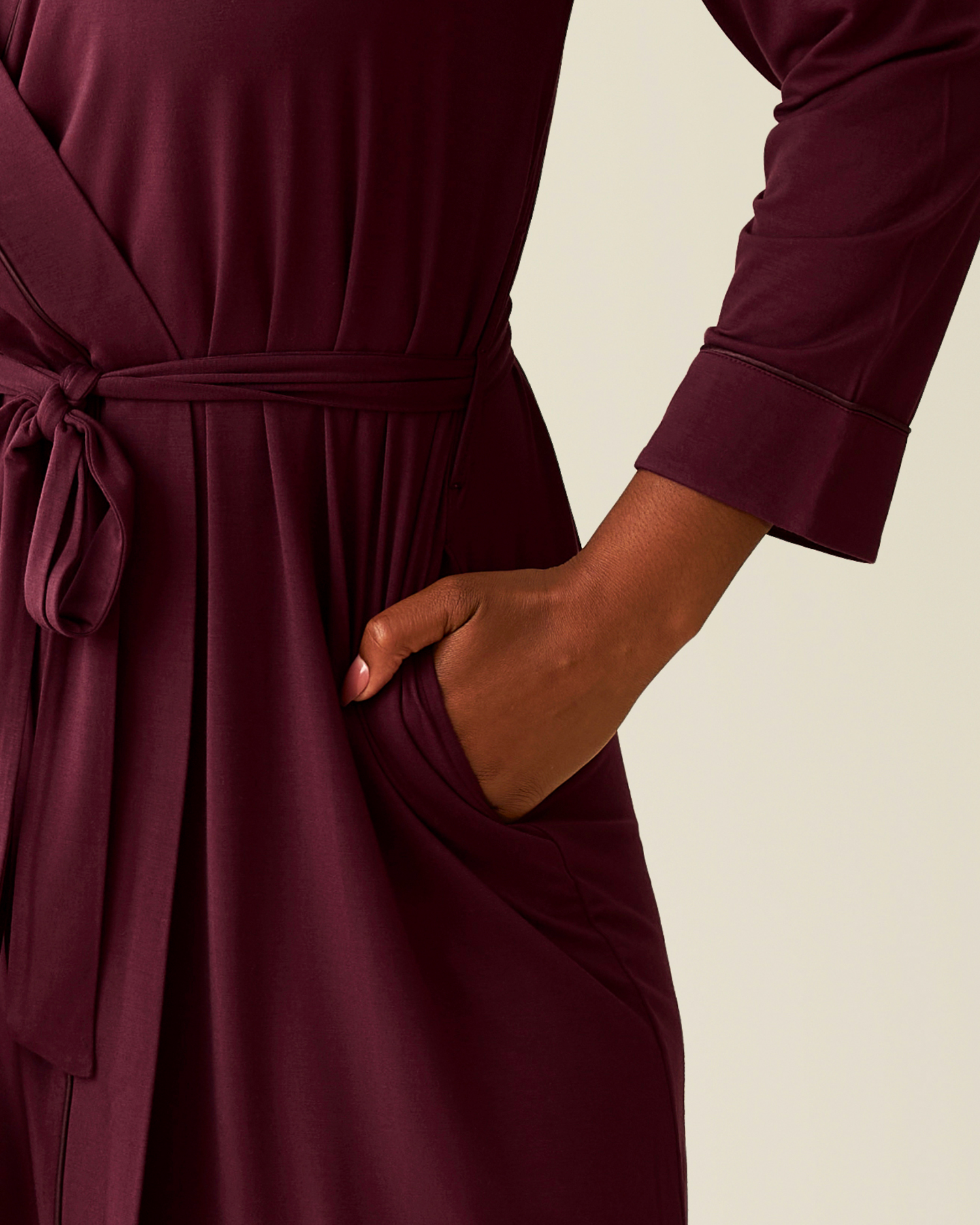 Cropped in image of woman wearing the Clea Bamboo Robe in Deep Burgundy, with hand in pocket