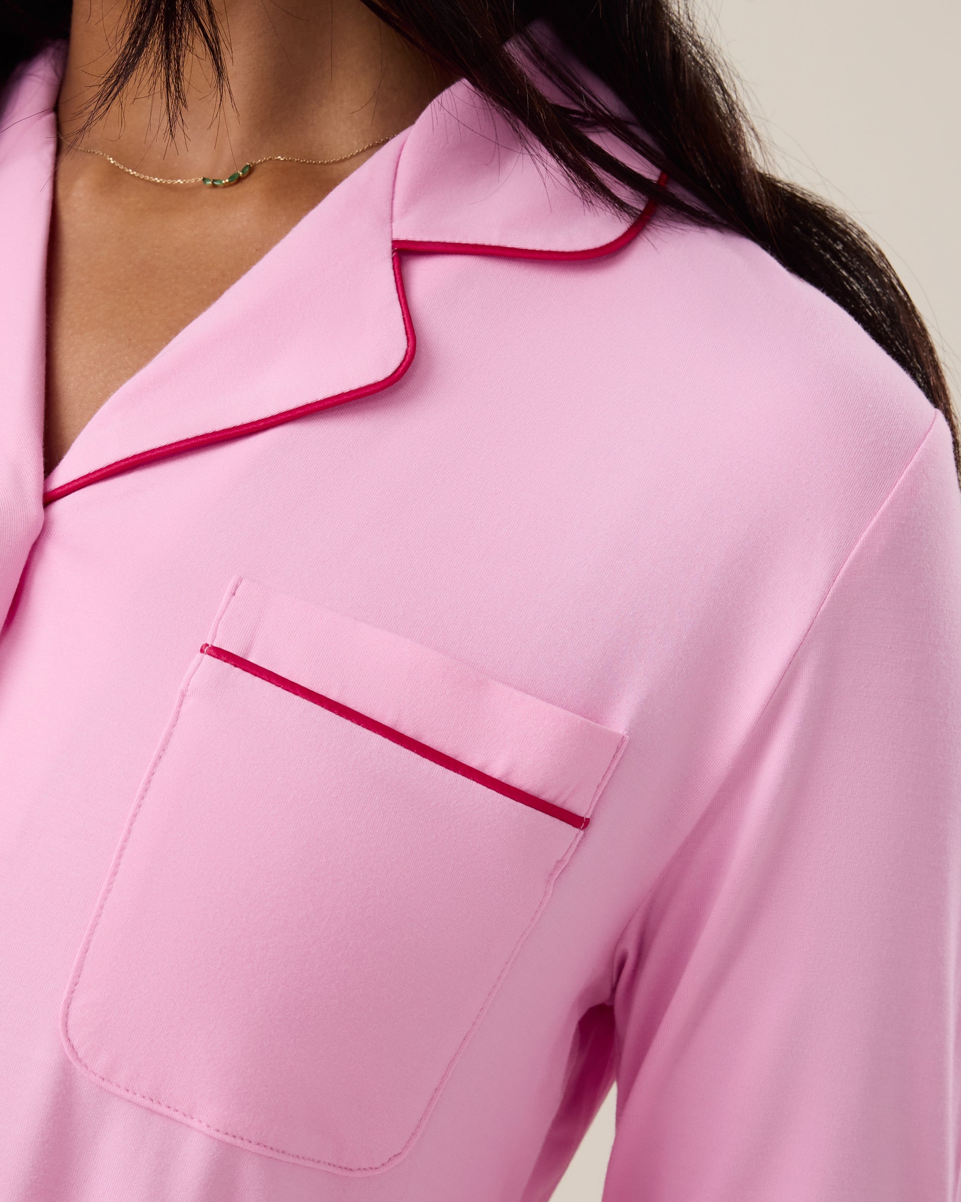 Close up collar detail of woman wearing the Clea Bamboo Long Sleeve Pajama Set in Bubblegum, showing piping detail