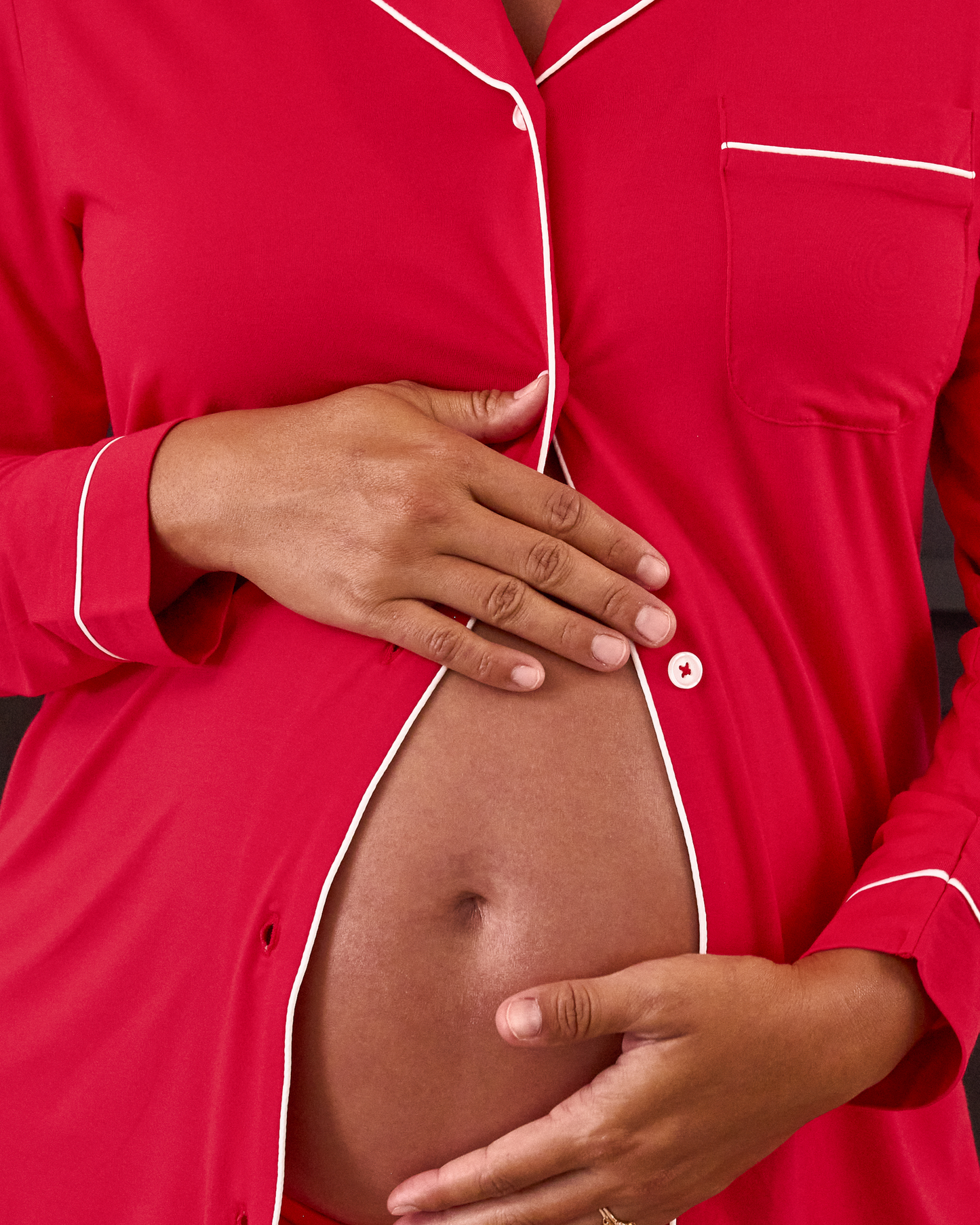 Pregnant woman wearing the Clea Bamboo Long Sleeve Pajama Set in Red, with white piping@model_info:Zoe is 5'7" and wearing a Medium.