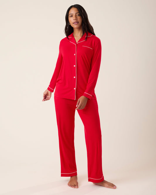 Woman wearing the Clea Bamboo Long Sleeve Pajama Set in Red, with white piping@model_info:Nemesis is 5'9" and wearing a Medium.