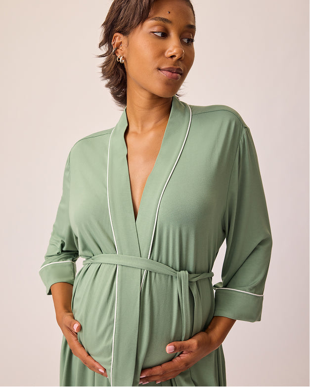 Back view of model wearing Clea Bamboo Robe in Sage on a beige background.