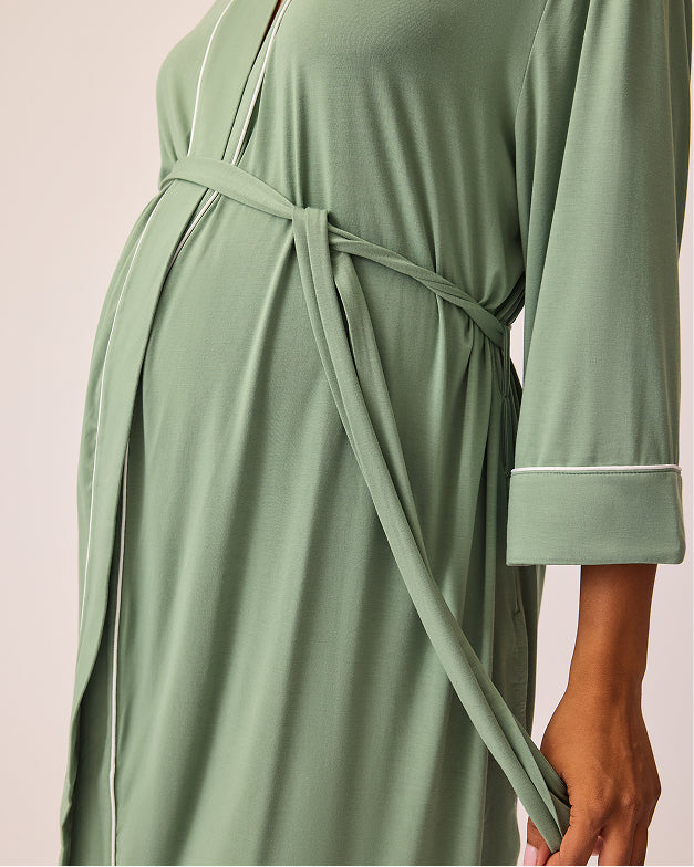 Side view of model wearing Clea Bamboo Robe in Sage on a beige background.