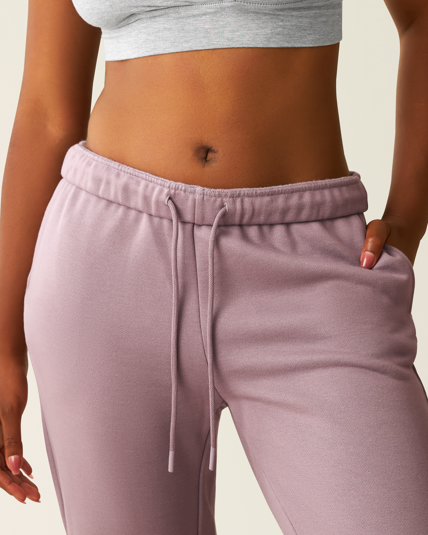 Cropped inclose-up of woman wearing the Cloud Fleece Jogger in Dusty Mauve, showing waistband and drawstring detail