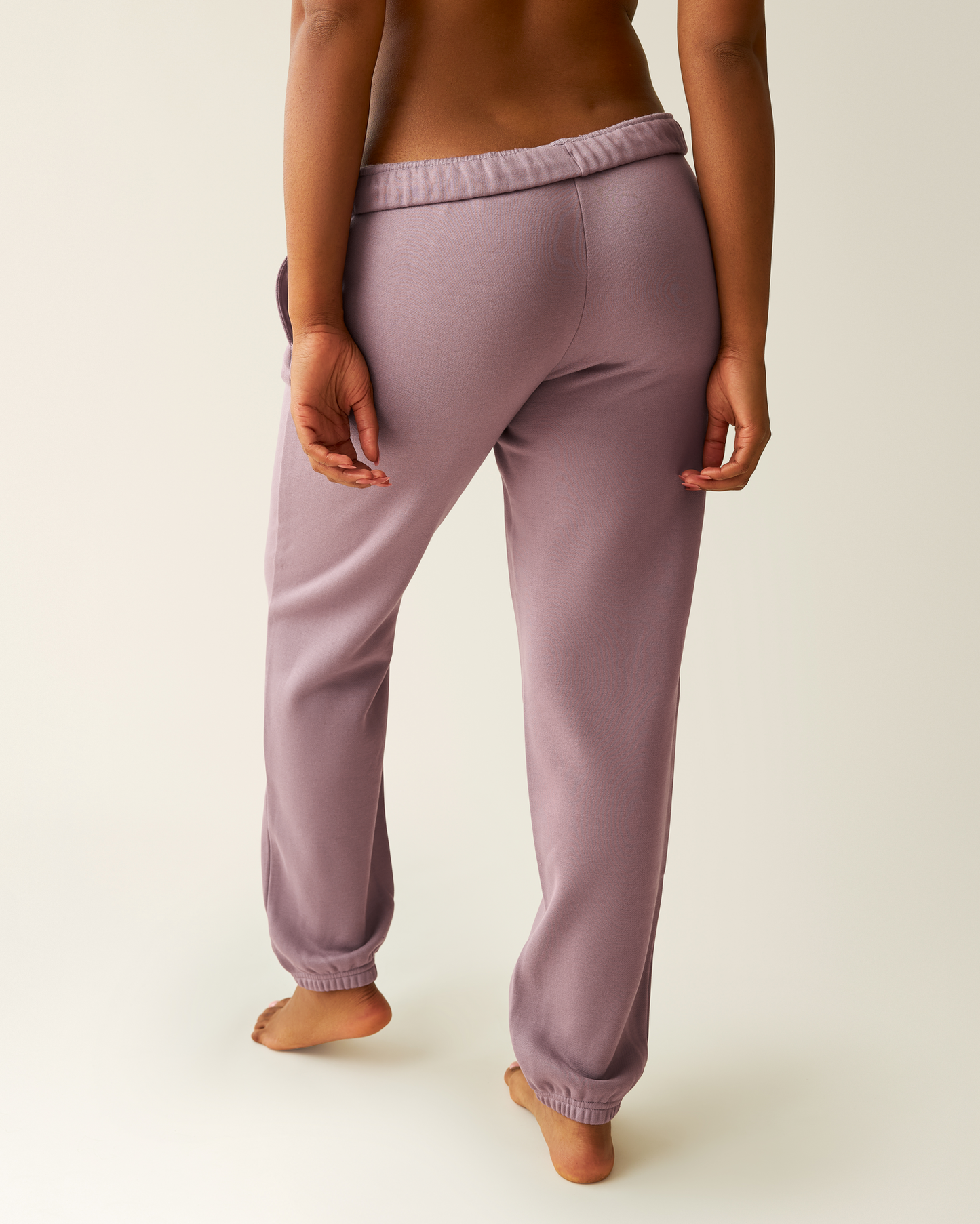 Cropped in image of woman wearing the Cloud Fleece Jogger in Dusty Mauve, showing back