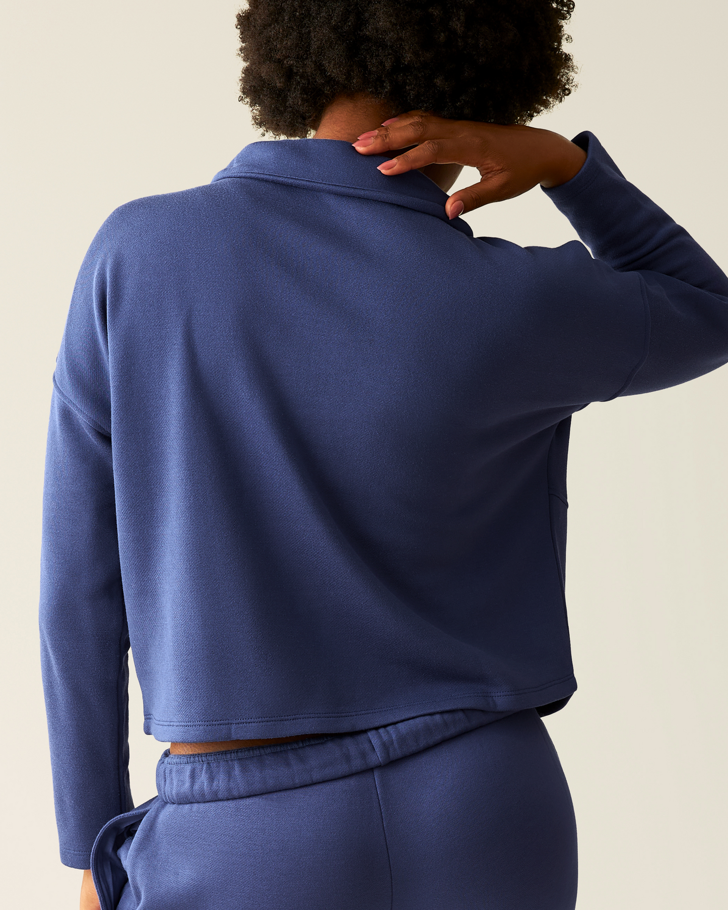 Back of woman wearing the Cloud Fleece Half Zip Pullover in Deep Blue