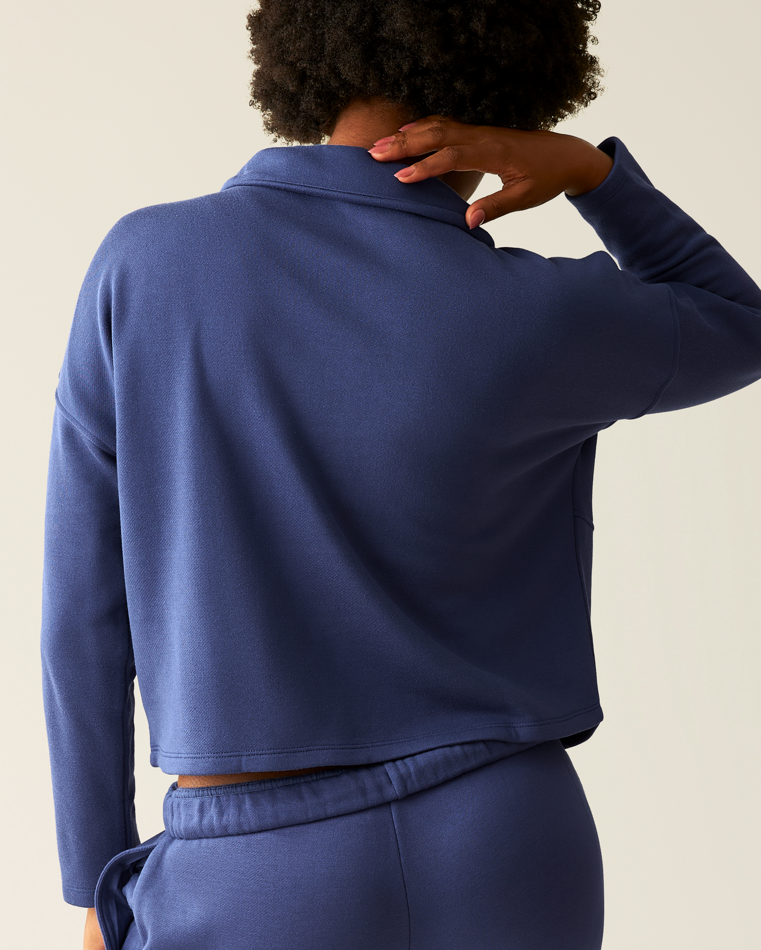 Back of woman wearing the Cloud Fleece Half Zip Pullover in Deep Blue