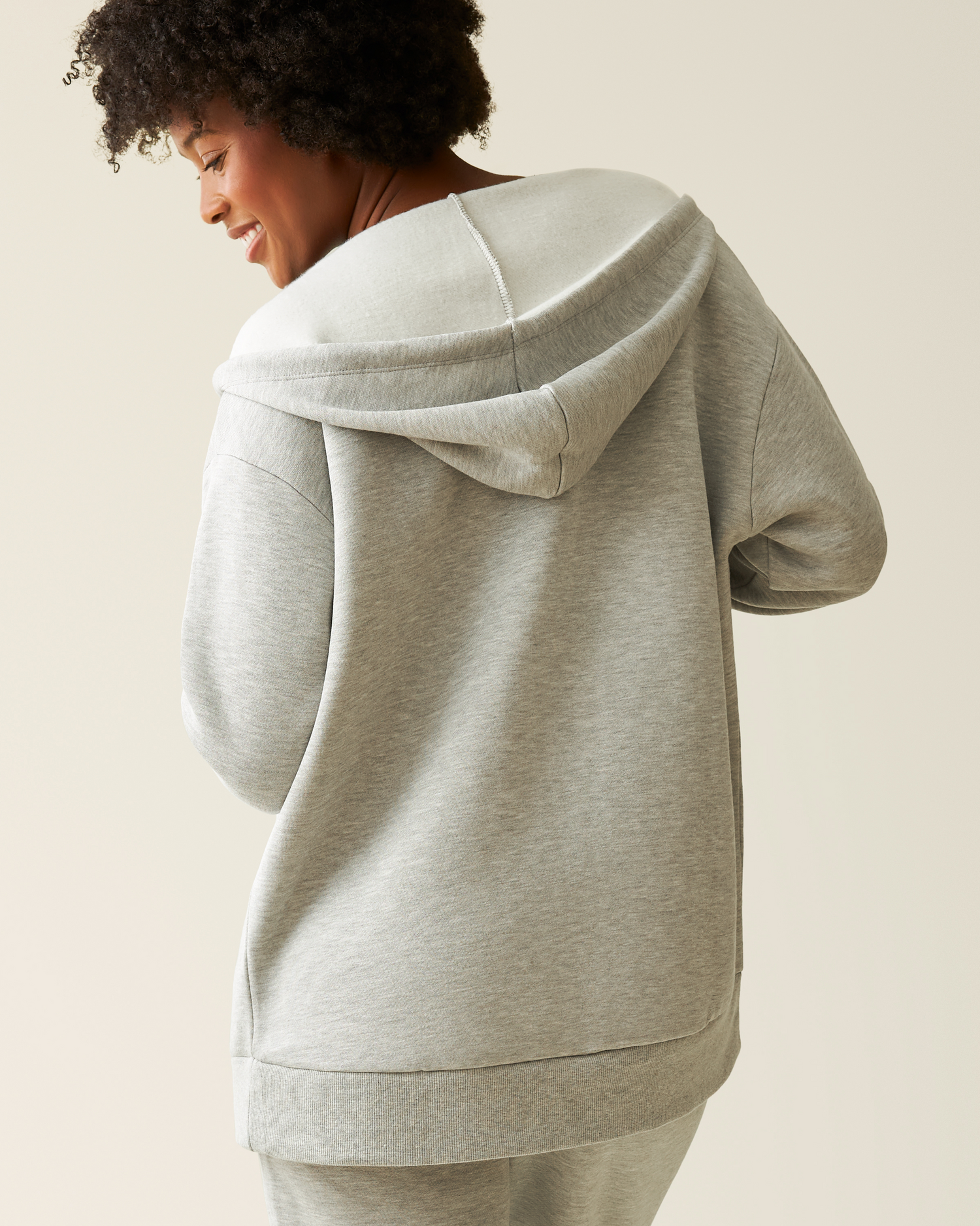 Back of woman wearing the Cloud Fleece Oversized Hoodie in Grey Heather 