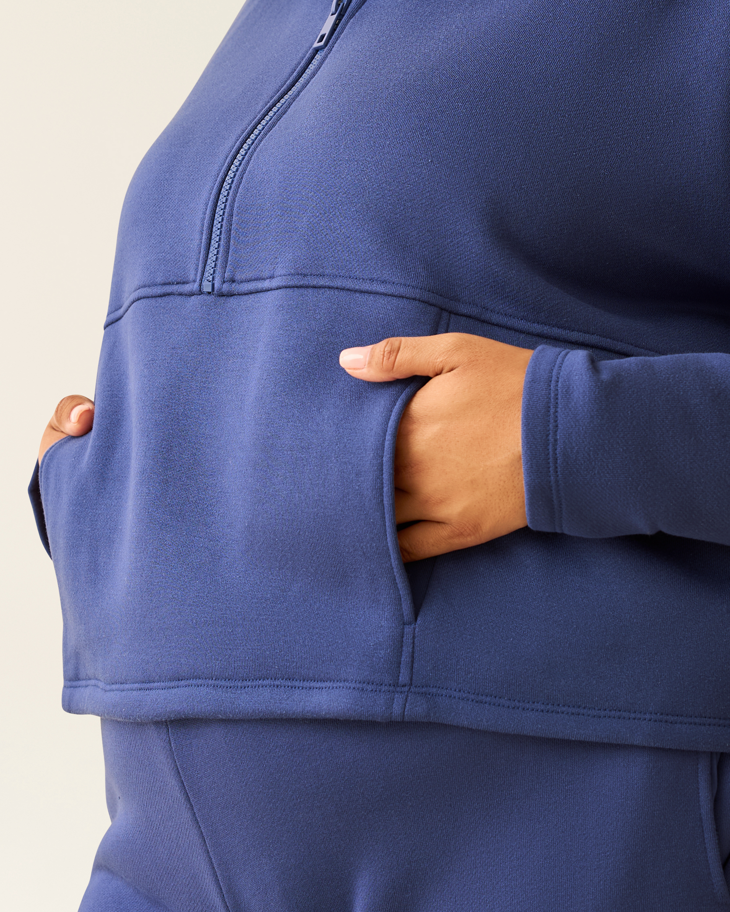 Close-up of woman wearing the Cloud Fleece Half Zip Pullover in Deep Blue showing pocket