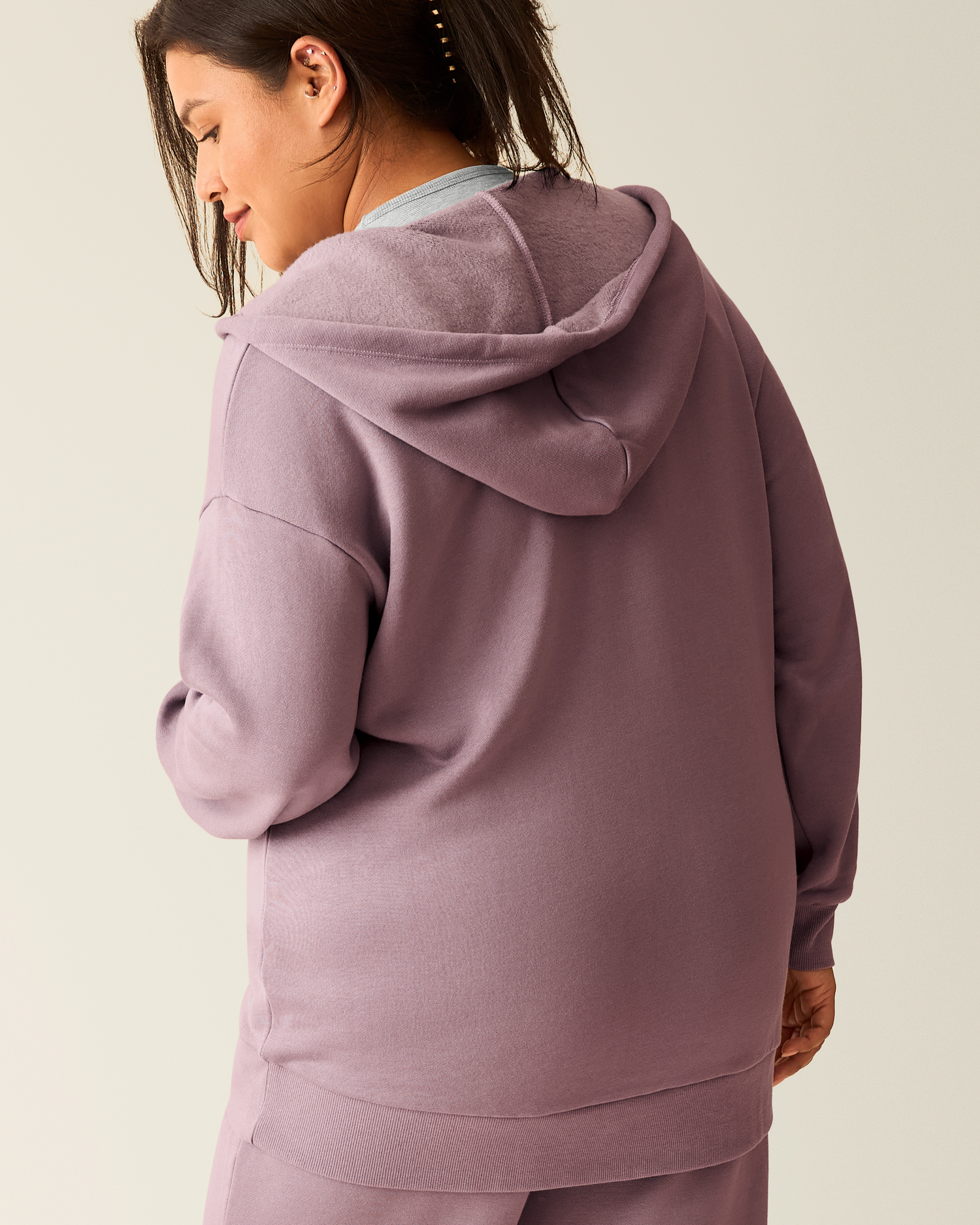 Back of woman wearing the Cloud Fleece Oversized Hoodie in Dusty Mauve 