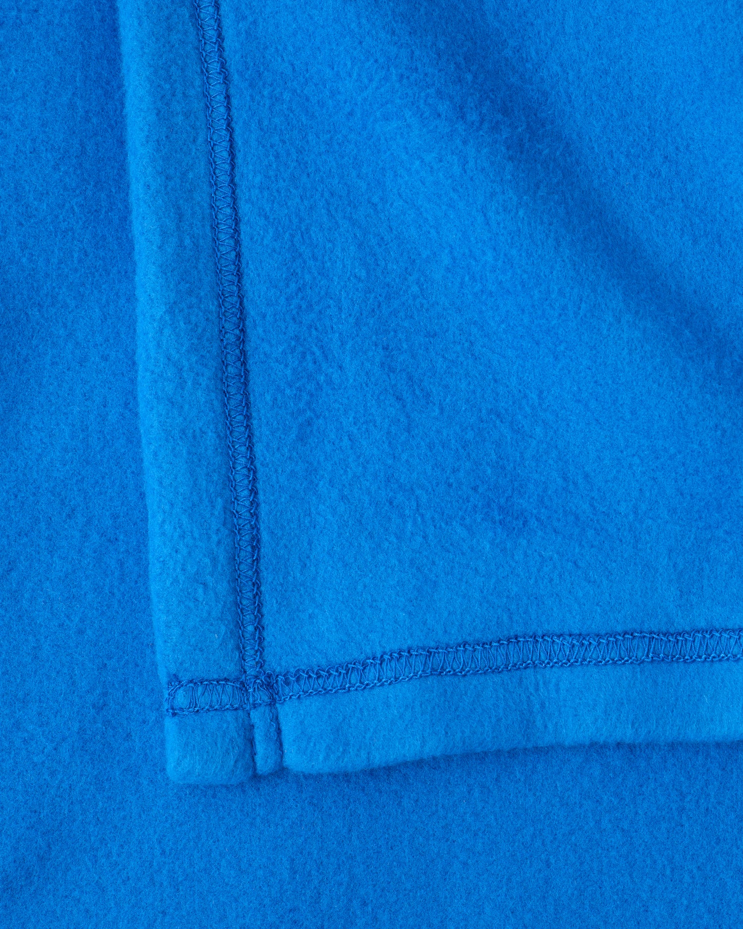 Close up image of the soft blanket of the Cool Kid Nap Mat in Blue & Rust Stripe.
