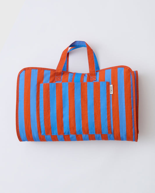 Cool Kid Nap Mat in Blue & Rust Stripe on a beige background.