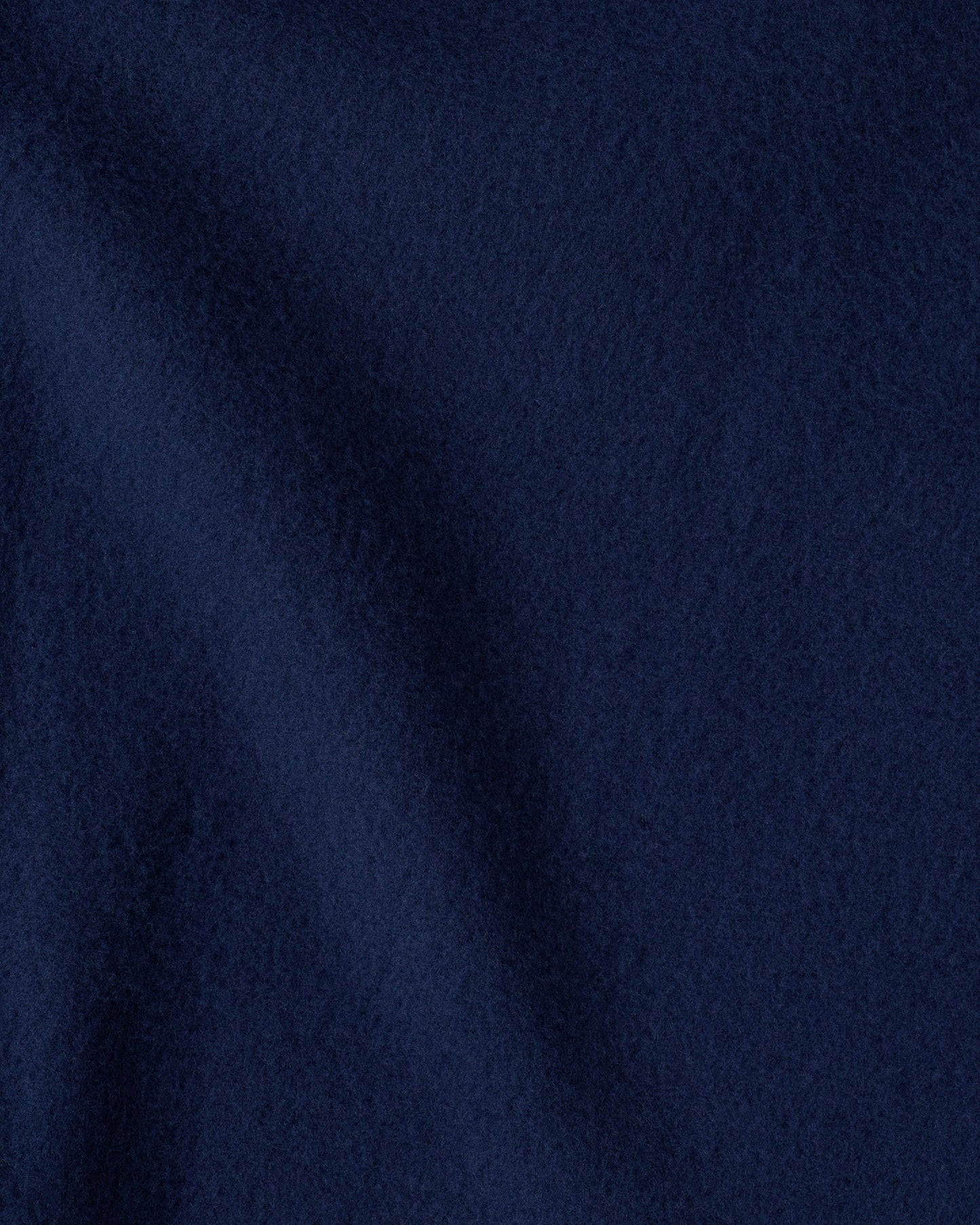 Close up image of the soft blanket of the Cool Kid Nap Mat in Navy & Green Stripe. 