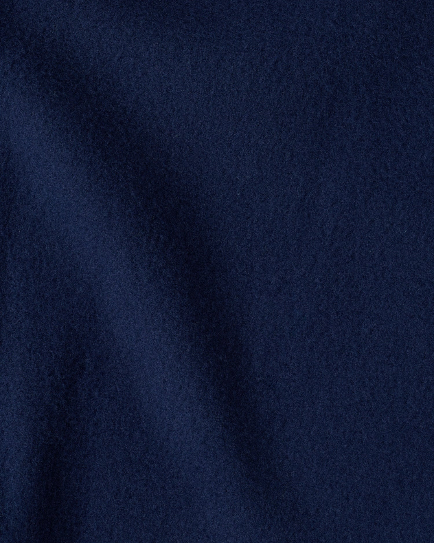 Close up image of the soft blanket of the Cool Kid Nap Mat in Navy & Green Stripe. 