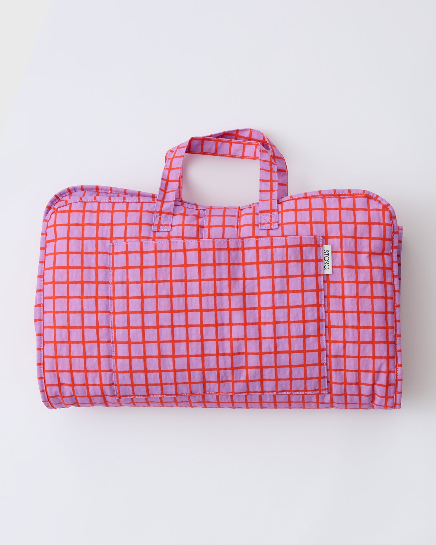 Cool Kid Nap Mat in Orchid Grid on a beige background.