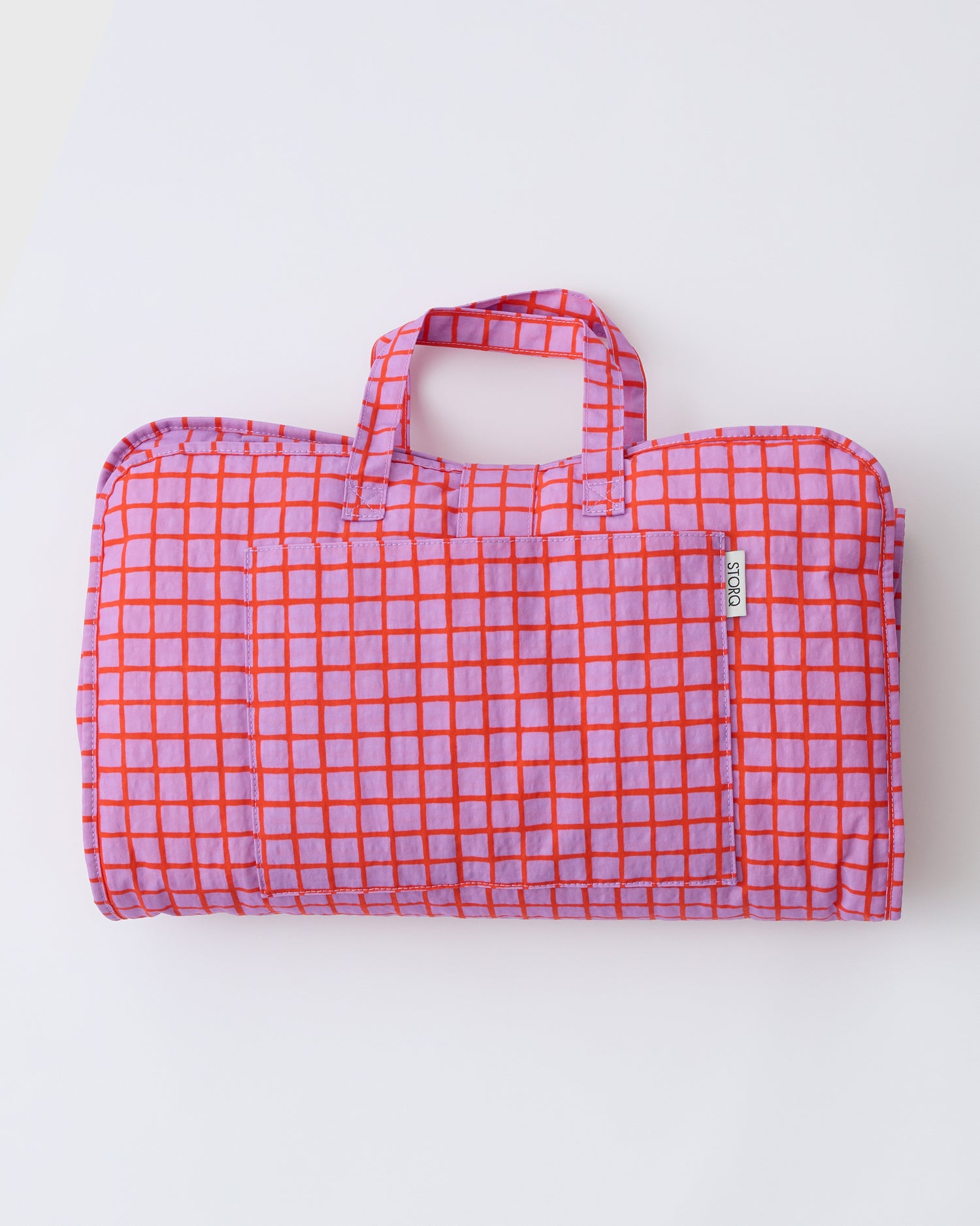Cool Kid Nap Mat in Orchid Grid on a beige background.
