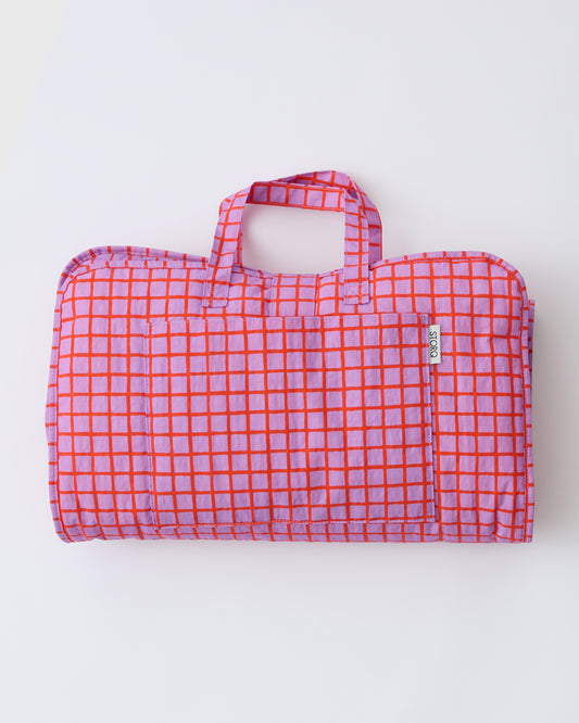 Cool Kid Nap Mat in Orchid Grid on a beige background.