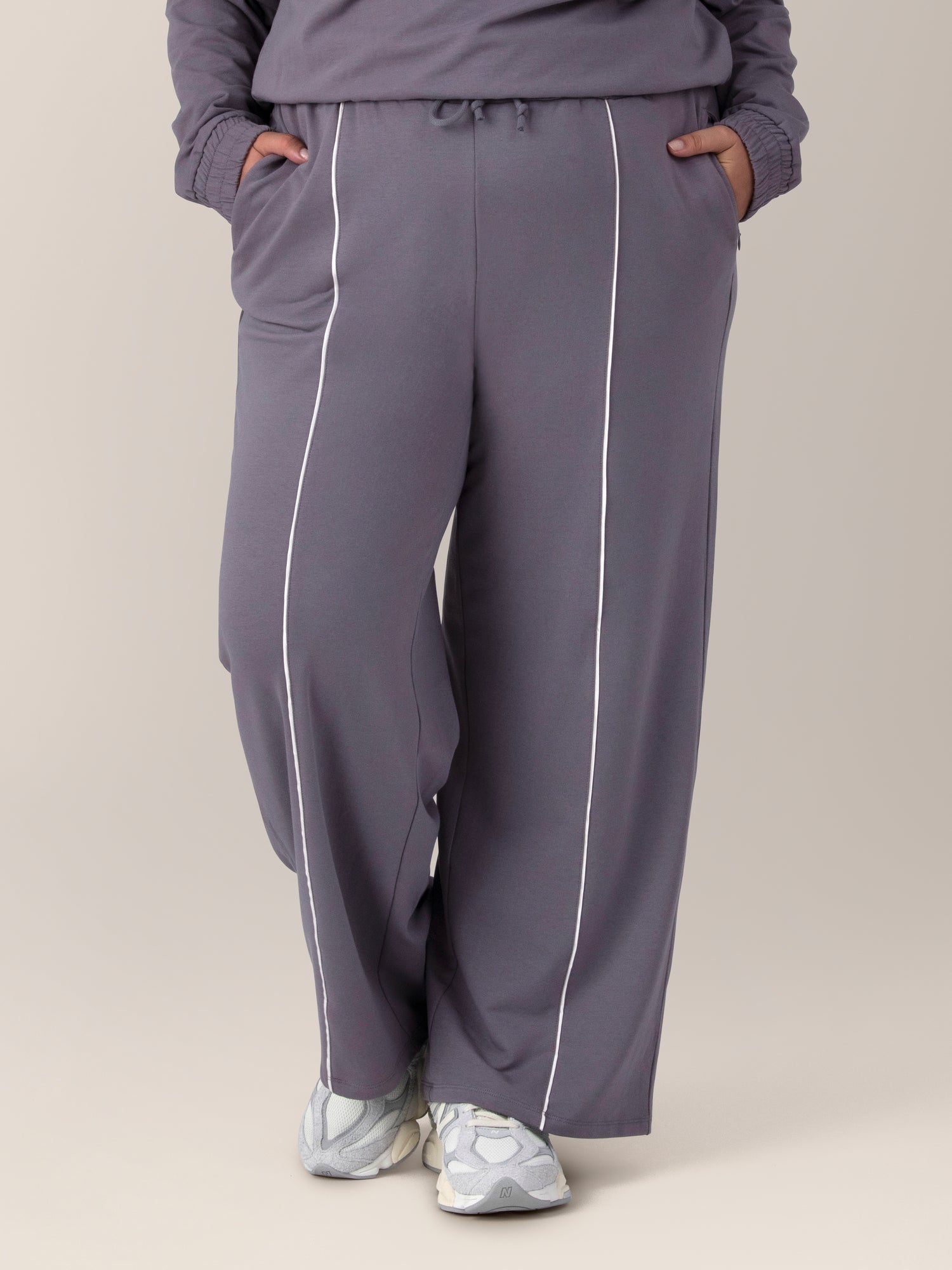 Front view of model wearing the Mila High-Waisted Wide Leg Pant in Granite, with hands in pockets