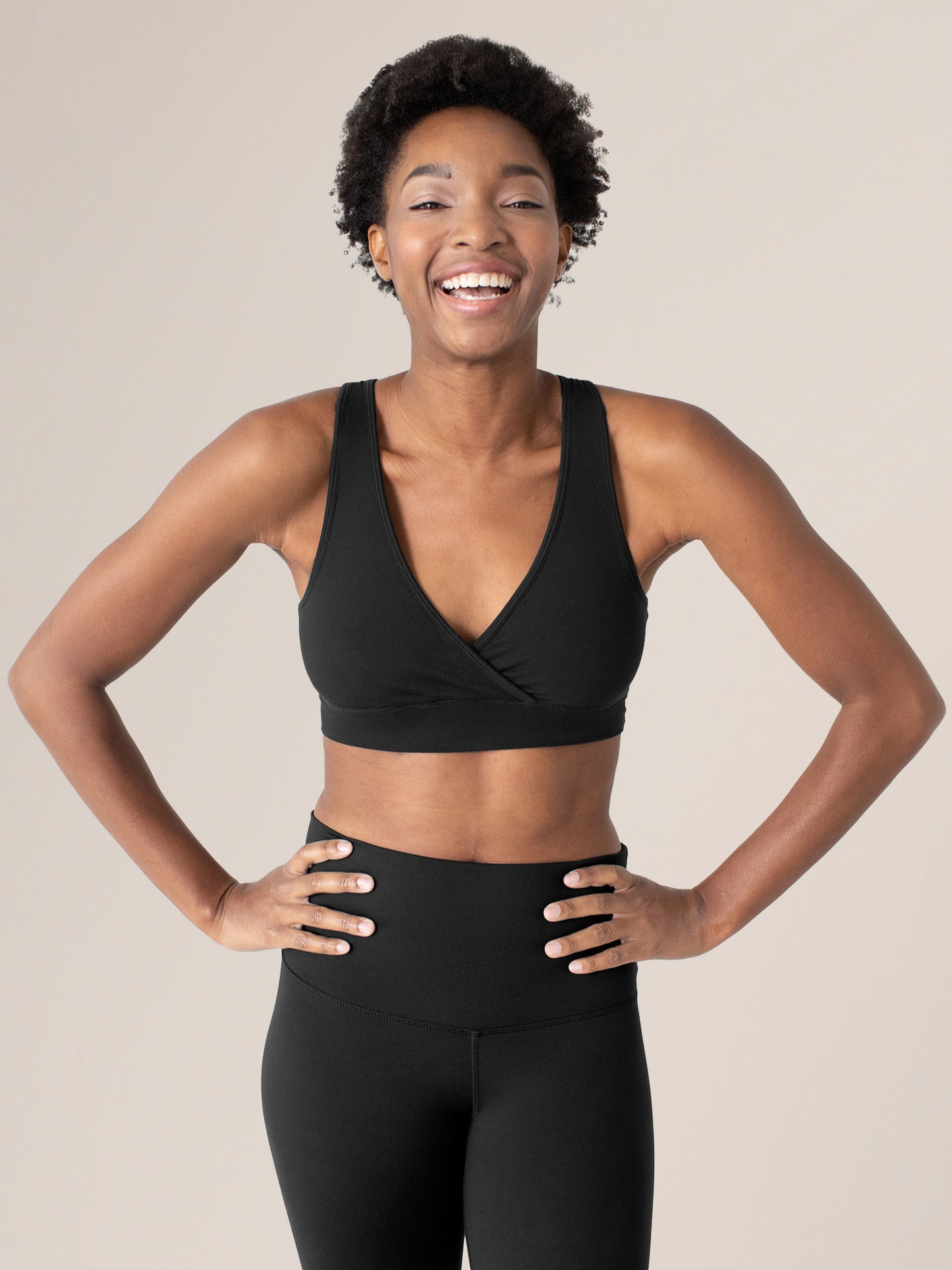 Model wearing the Organic Cotton Sleep & Nursing Bra in Black @model_info:Ayo is wearing a Small.