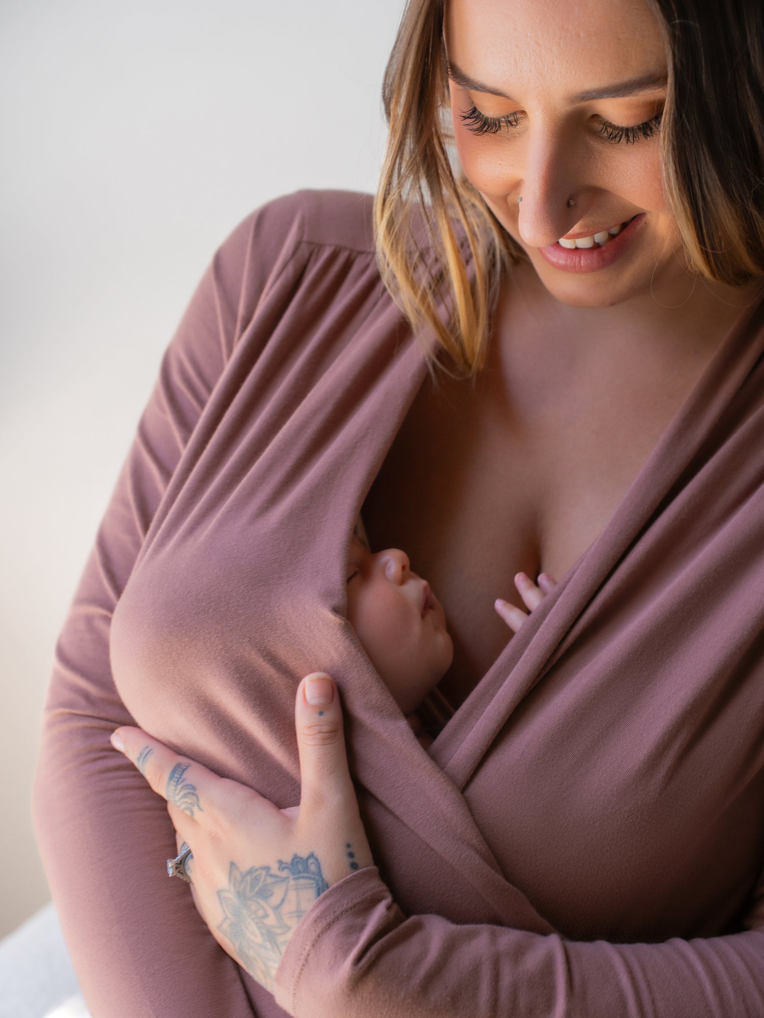 Close up of baby wrapped in the Organic Cotton Skin to Skin Long Sleeve Wrap Top in Twilight worn by model mom.