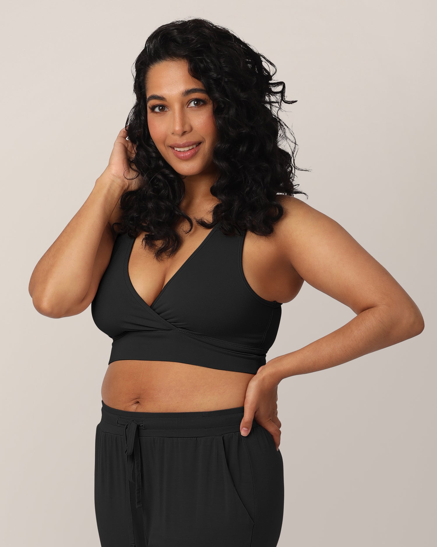 3/4 view of model wearing the French Terry Racerback Nursing & Sleep Bra in Black @model_info:Zakeeya is wearing a Small.