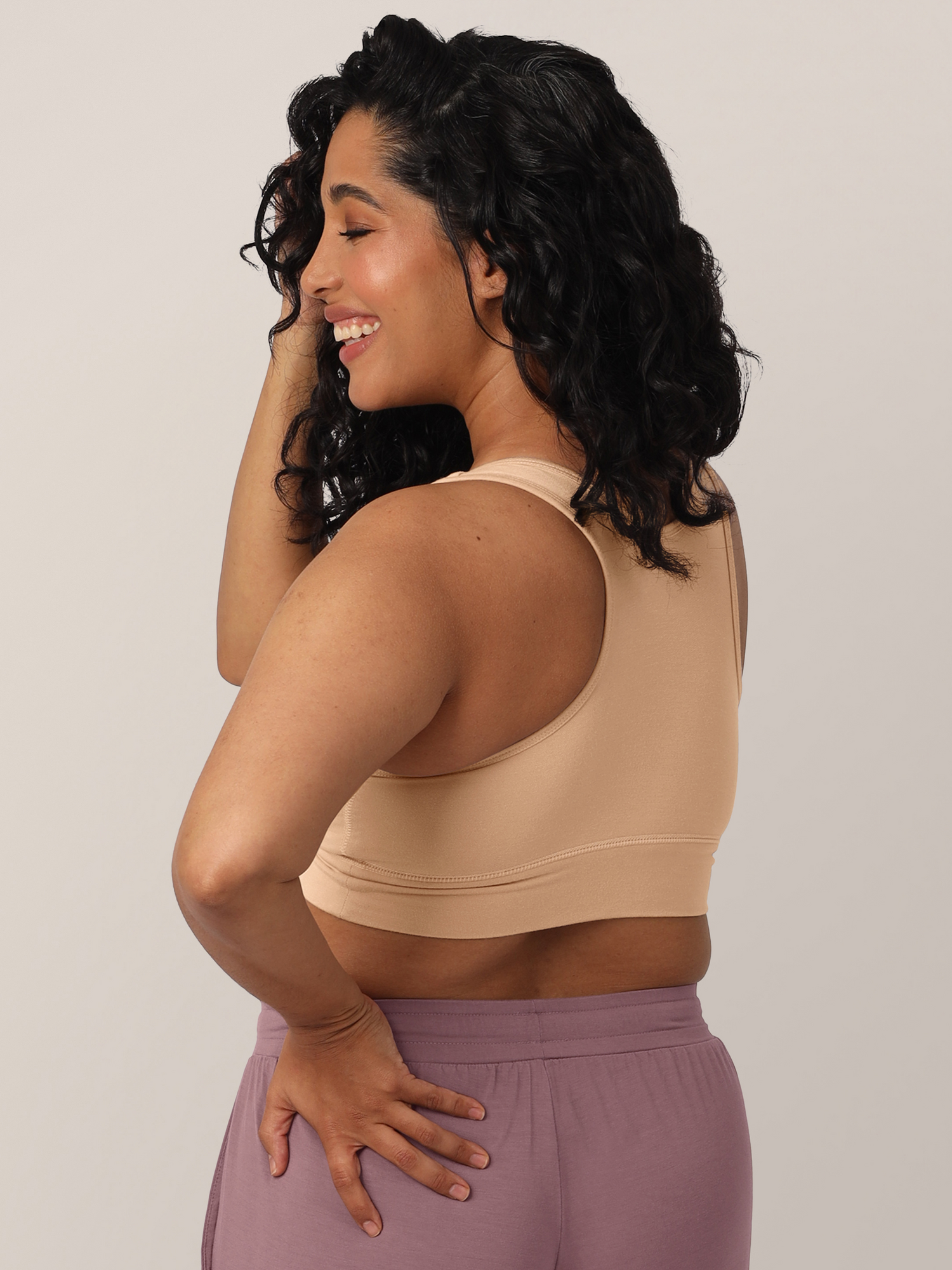 Back angled view of model wearing the French Terry Racerback Nursing & Sleep Bra in Beige 