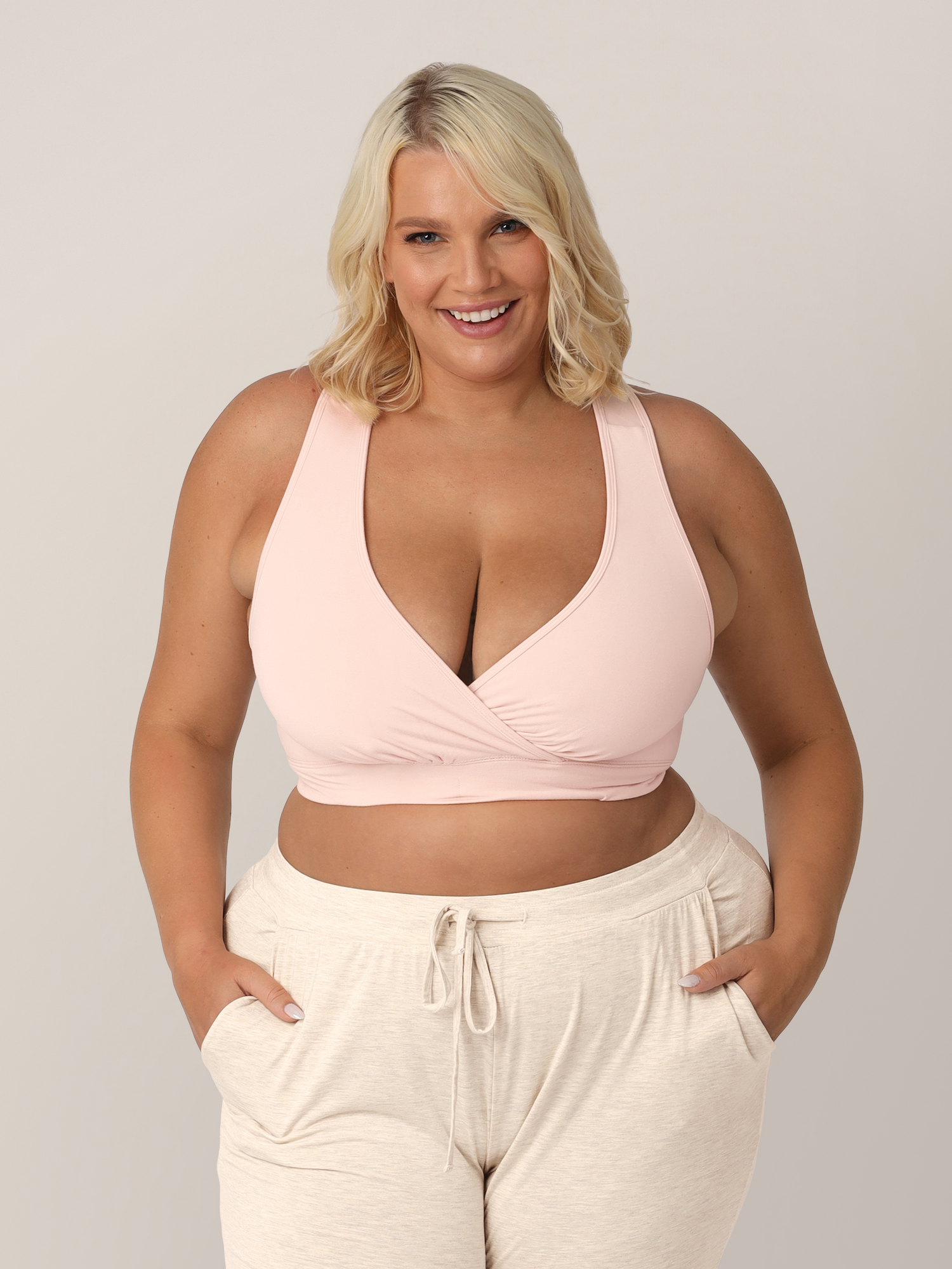 Front view of model wearing the French Terry Racerback Nursing & Sleep Bra in in Soft Pink in busty size. @model_info:Lauren is wearing an X-Large Busty.