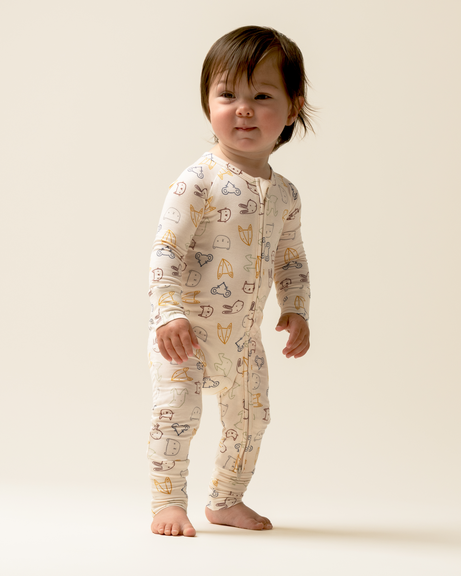 Child wearing Bamboo Baby Pajamas in Critter Crew on a plain background@model_info:Mosey is wearing 3-6 months.