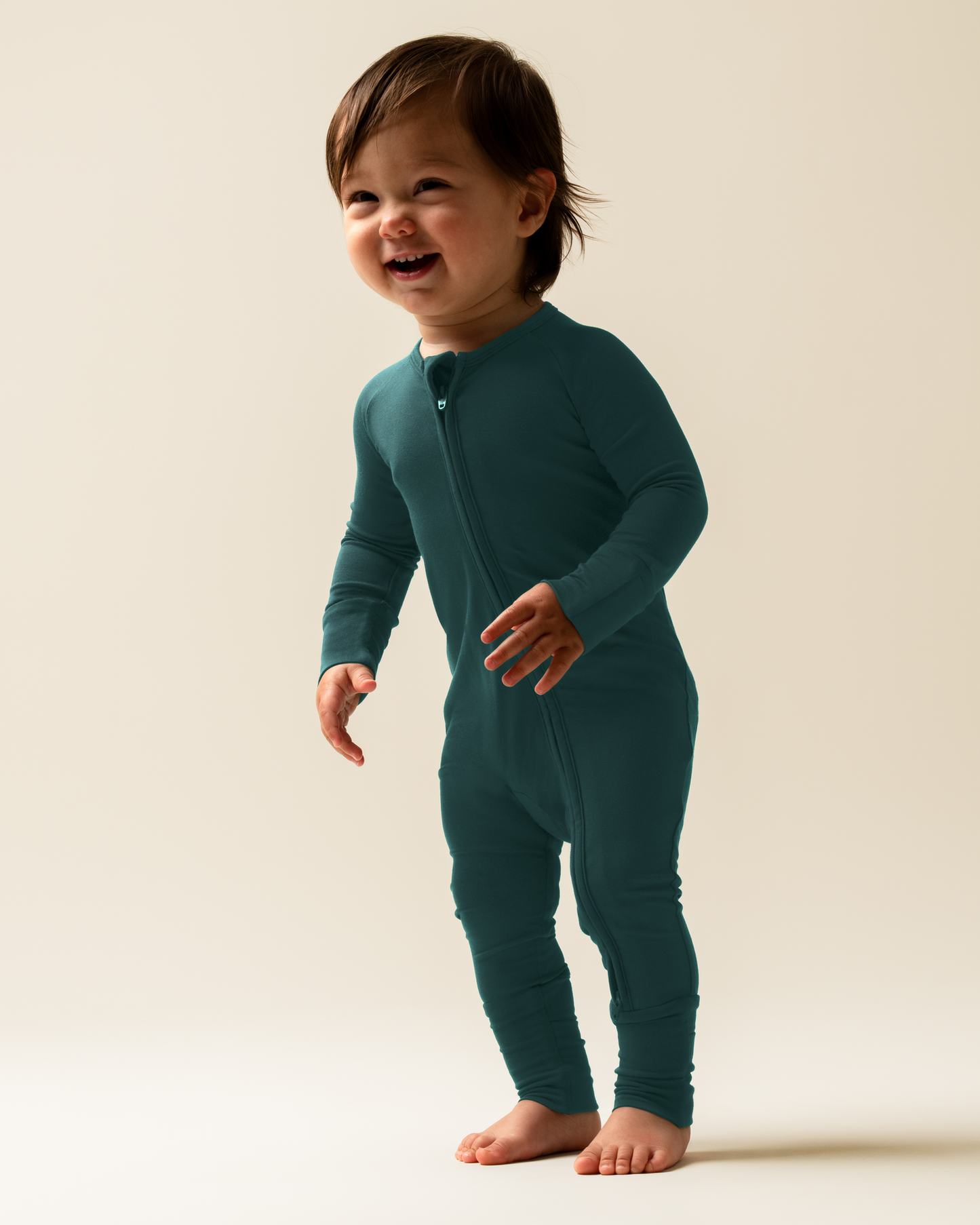Child wearing Bamboo Baby Pajamas in Evergreen against a plain background@model_info:Mosey is wearing 3-6 months.