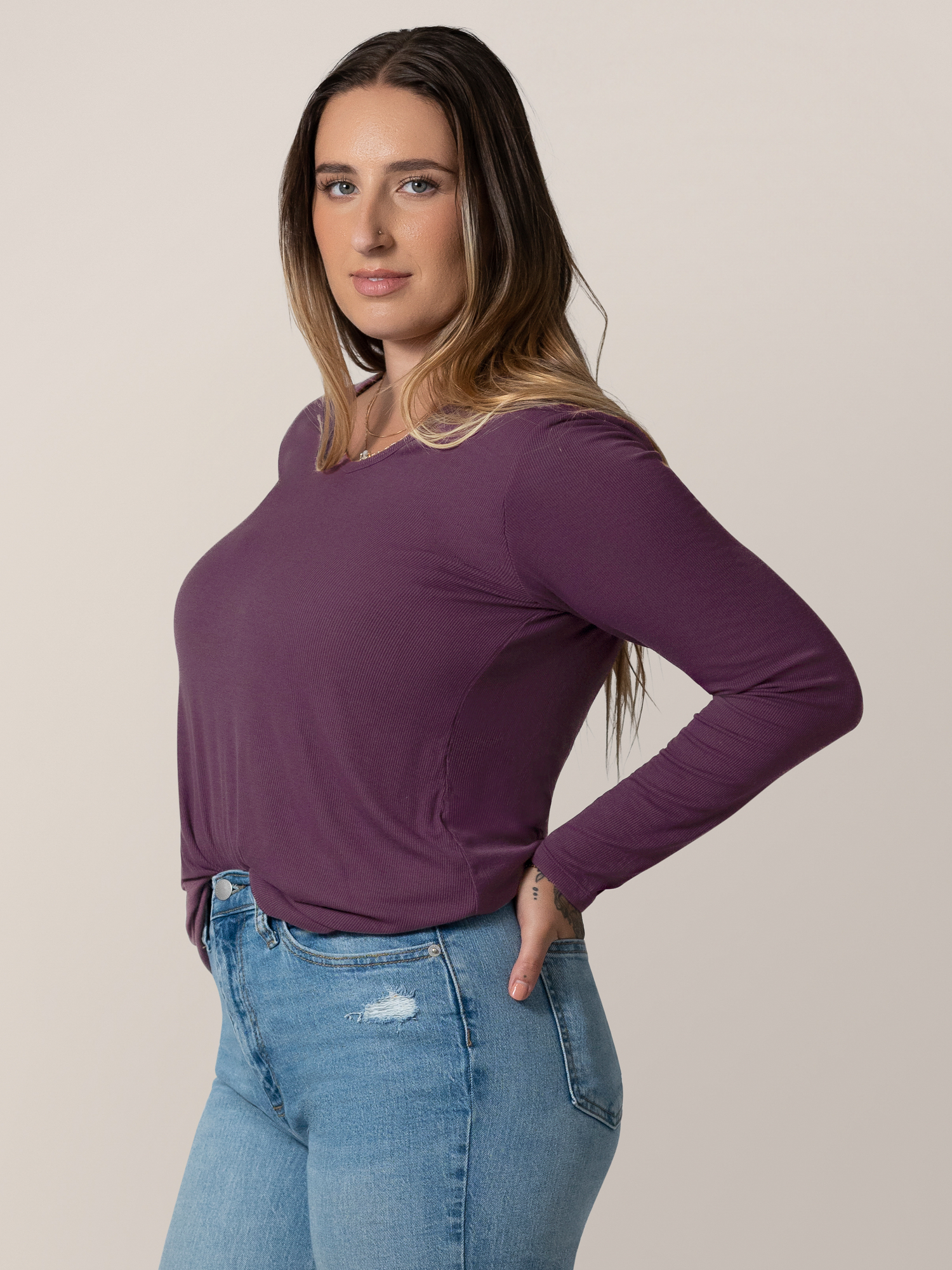 3/4 front view of model wearing the Ribbed Bamboo Maternity & Nursing Long Sleeve T-shirt in Mulberry, tucked into jeans