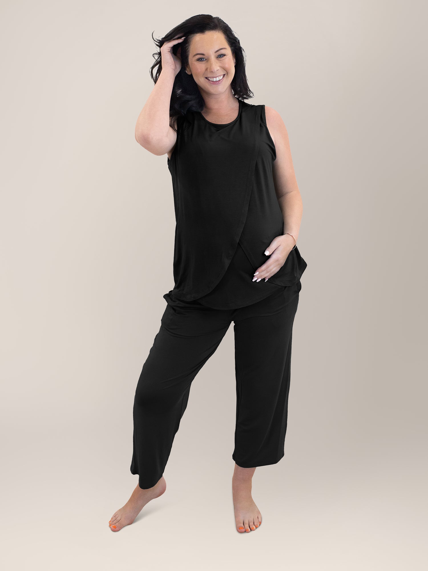 Front view of pregnant model wearing the Tulip Hem Nursing Tank & Capri Pajama Set in Black. @model_info:Alicia is wearing a Medium.