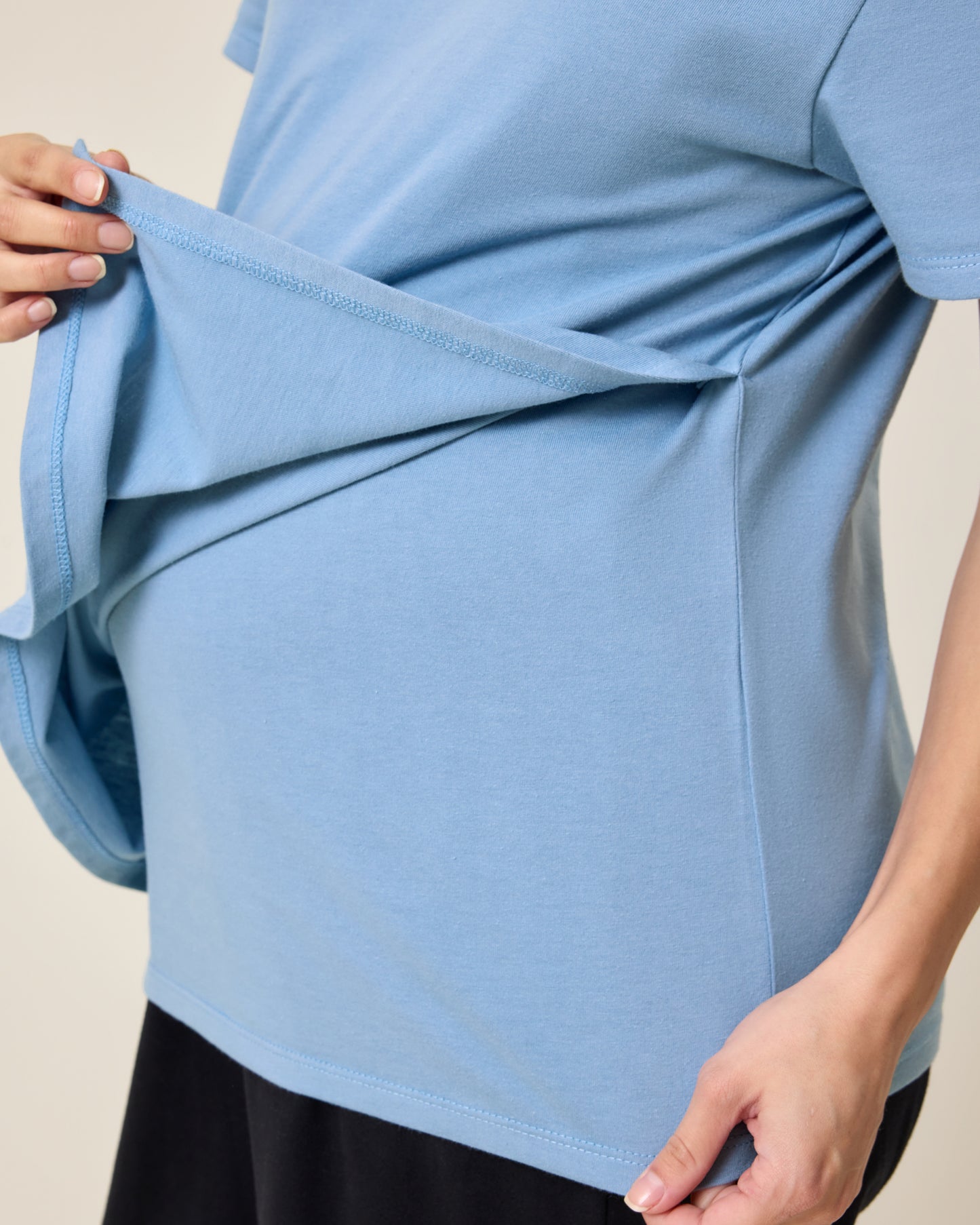 Close up of model wearing Relaxed Cotton Maternity & Nursing T-shirt in Vintage Blue showing how the front panel lifts for breastfeeding access