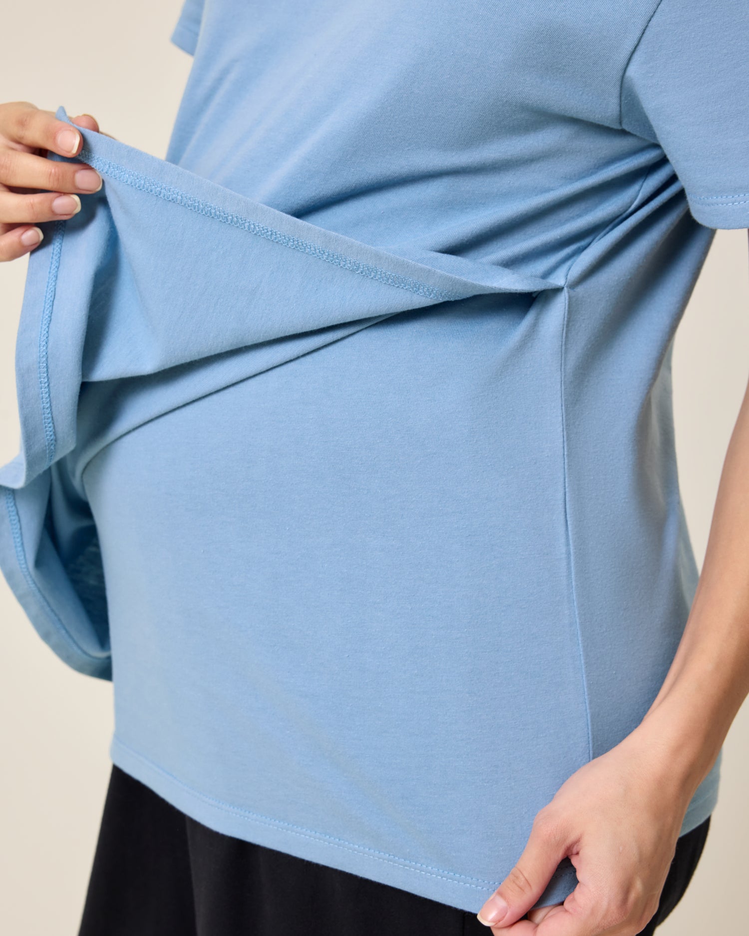 Close up of model wearing Relaxed Cotton Maternity & Nursing T-shirt in Vintage Blue showing how the front panel lifts for breastfeeding access