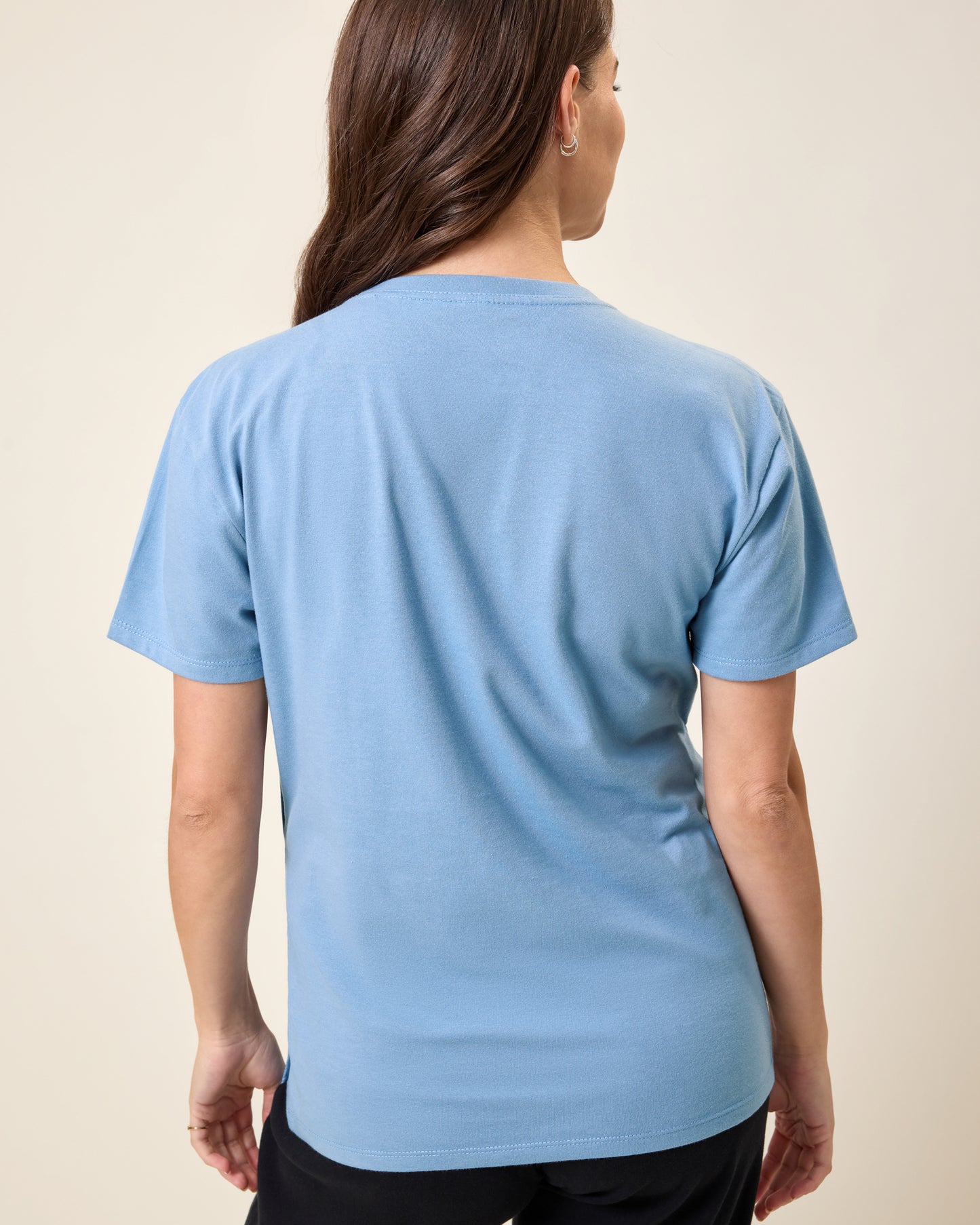 Back view of model wearing Relaxed Cotton Maternity & Nursing T-shirt in Vintage Blue on a neutral background